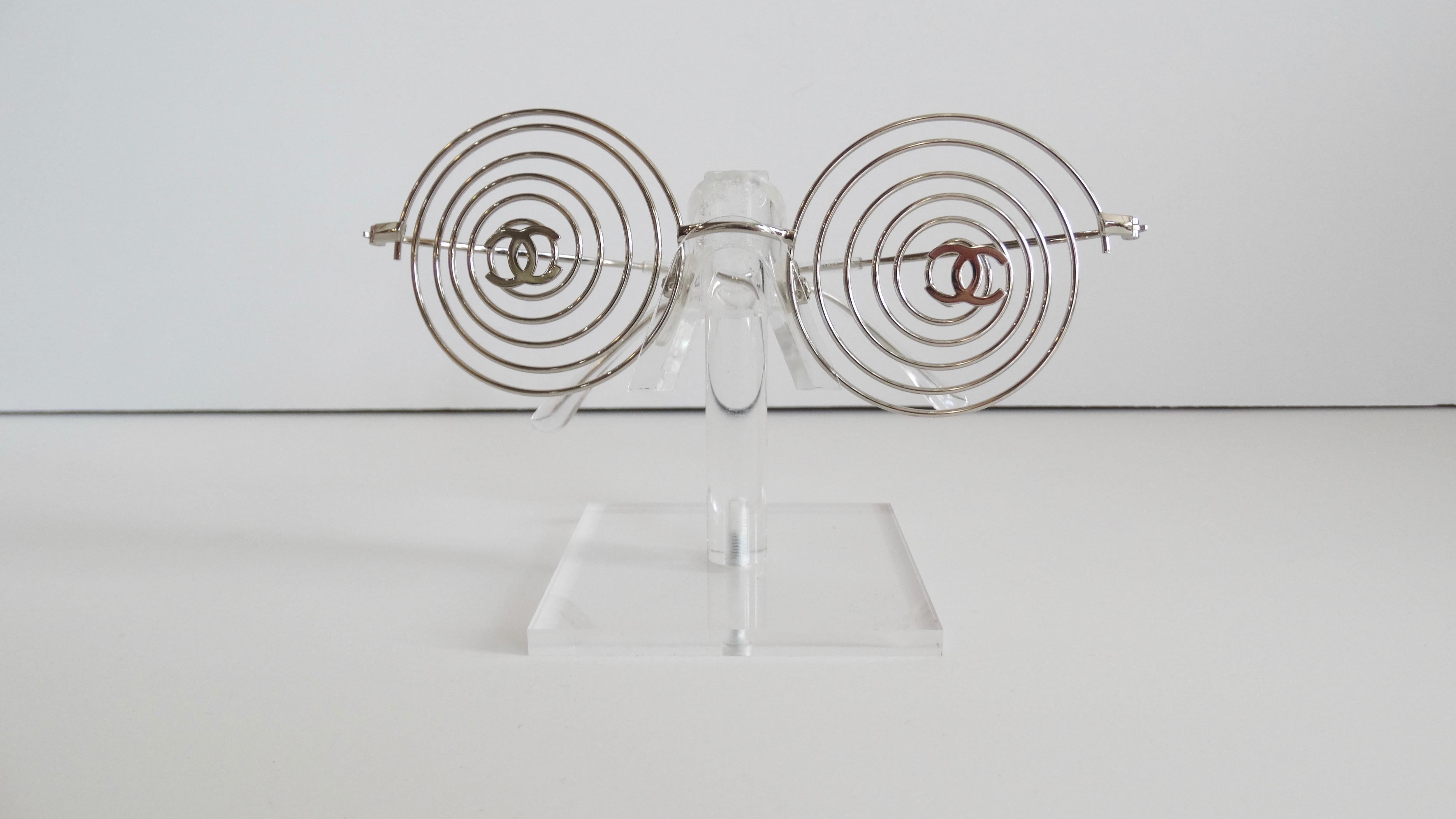 Score yourself a piece of fashion history with our Karl Lagerfeld era Chanel glasses circa 1996! From the same iconic collection that gave us the tiniest Chanel bikini ever, comes this incredible pair of silver spiral fashion frames. Metallic frames