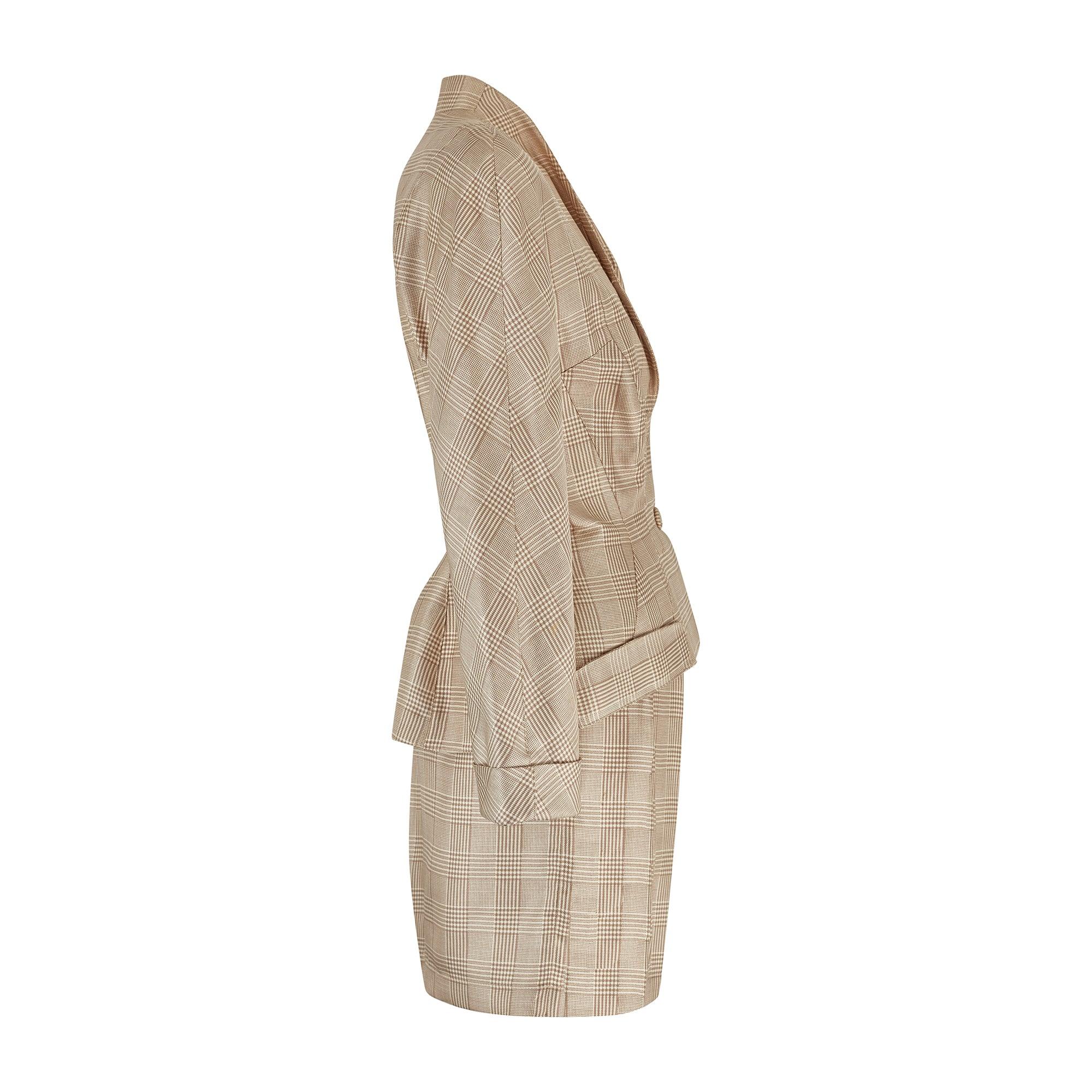 This Thierry Mugler silk skirt suit walked the runway for his Spring 1996 collection. The peplum-shaped suit jacket with shoulder pads draws in the waist and adds volume around the hips, emphasising and highlighting the feminine figure. The jacket