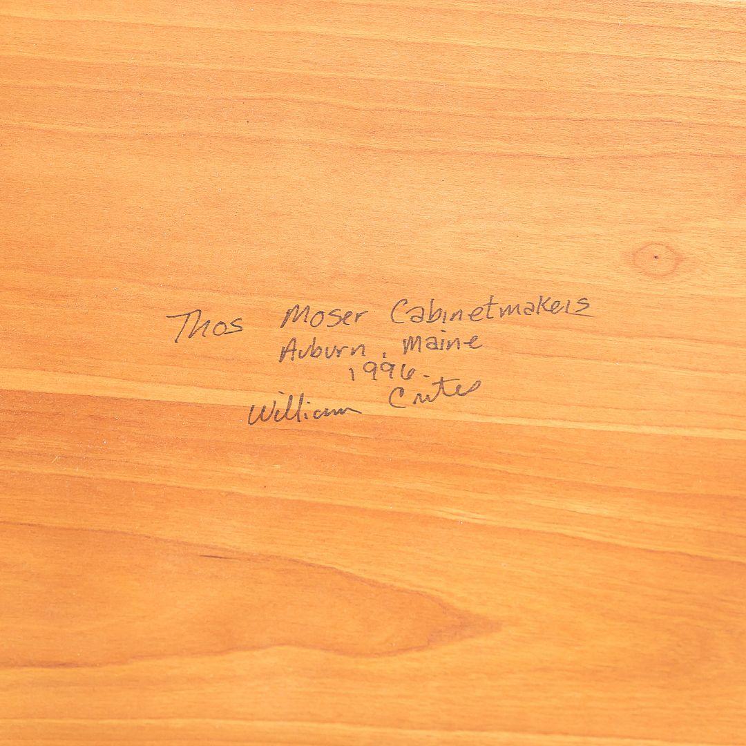 This is a Round Ring table which was originally designed by Thomas Moser. This particular example was produced by The Moser Cabinetmakers in the USA during 1996. This table is made of solid cherry wood and the fine grain can be seen throughout it's