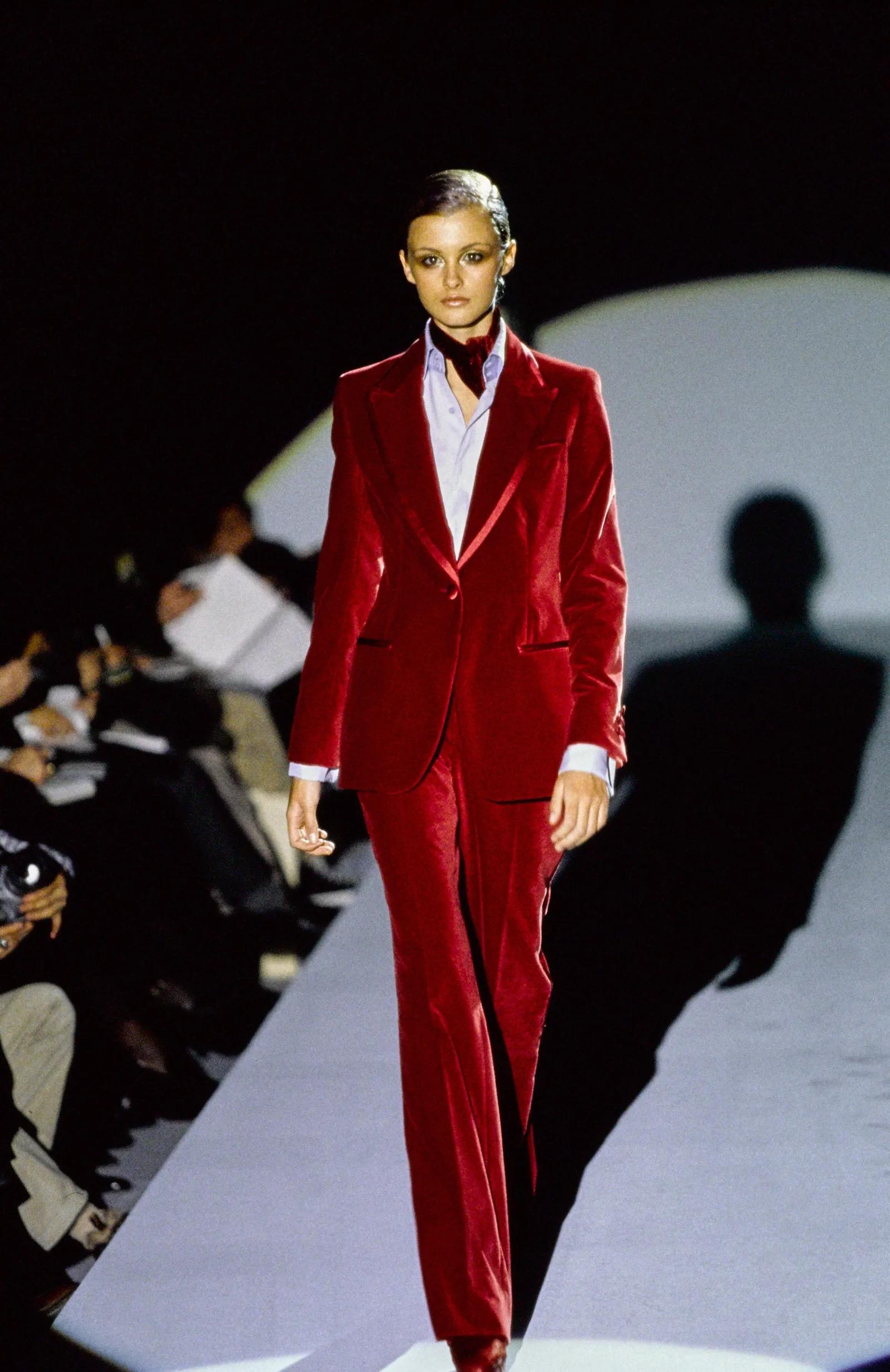 An absolutely gorgeous and instantly recognizable Gucci by Tom Ford red velvet pantsuit dating back to his 1996 fall/winter runway collection. This epic set was runway look 39 modeled by the stunning Trish Goff. He revisited the design throughout