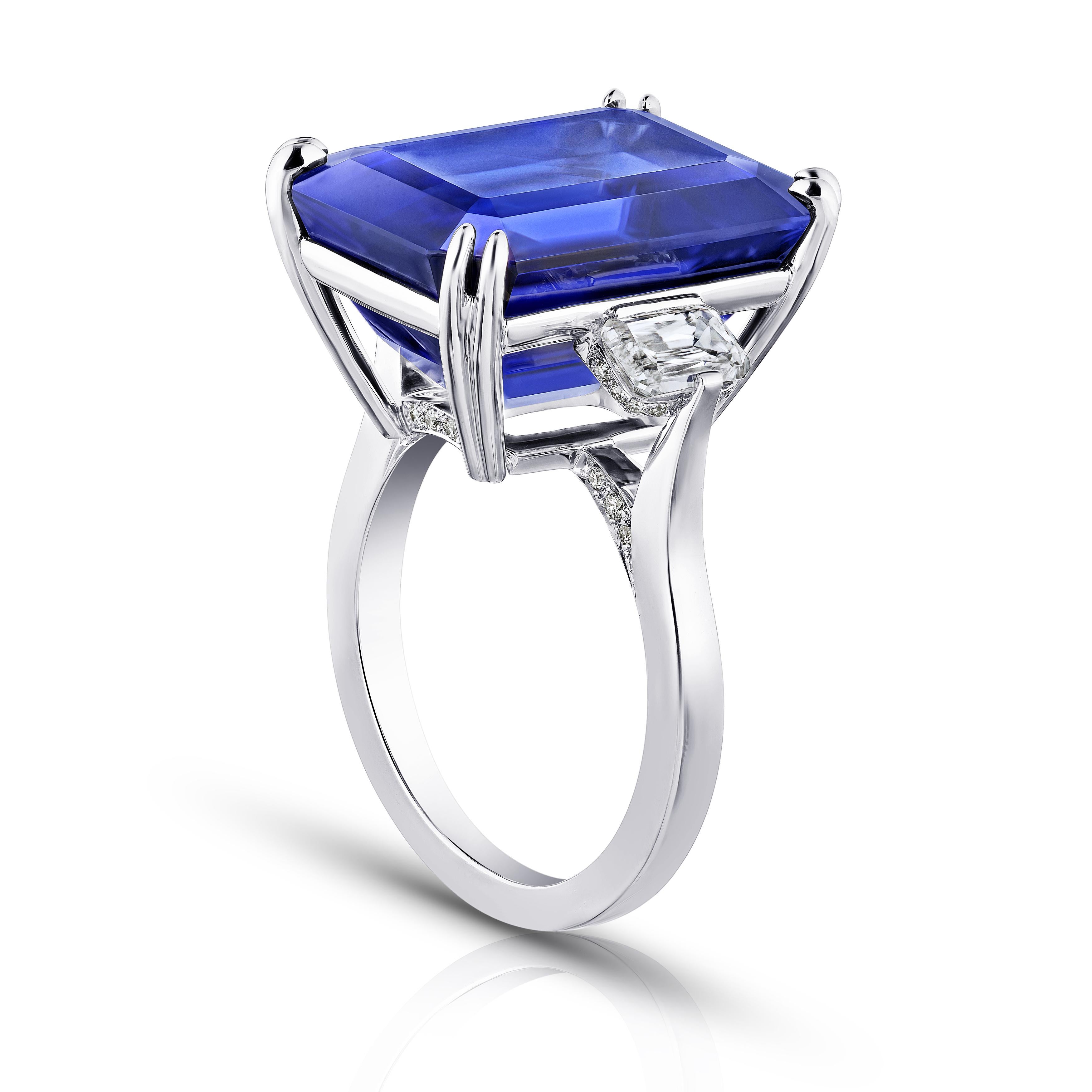 19.97 carat emerald cut blue tanzanite with 2 antique cushion diamonds 1.02 carats and 36 round diamonds .14 carats set in a platinum ring. Size 7. Resizing to your finger size is free. This tanzanite is loupe clean and exception color and