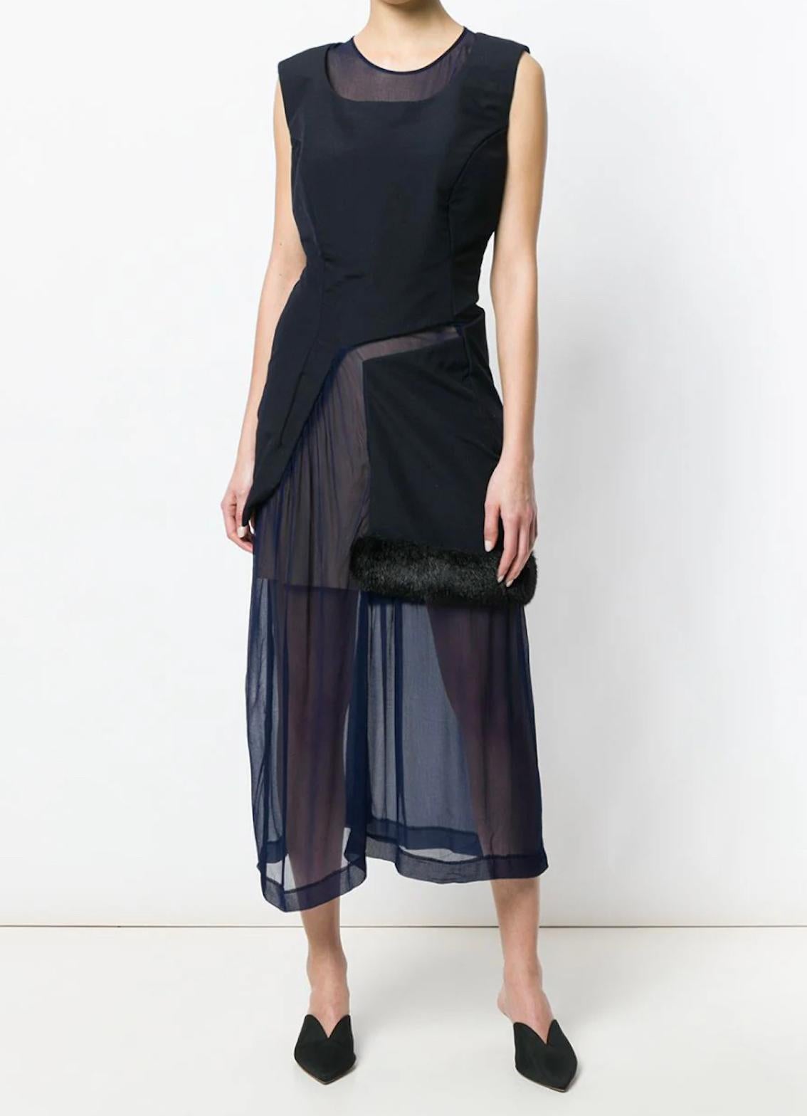 Exquisite sheer construction, this navy blue runway dress displays a lovely fur effect trim detailing topped over the fluttering long skirt. Crafted in '97, it features a round neck, an invisible back zip fastening, a sleeveless design, a fitted
