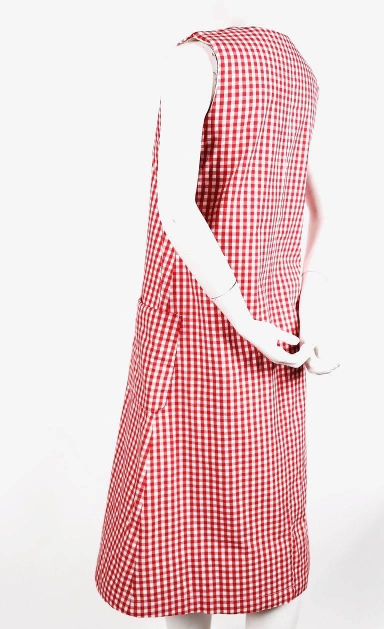 Red gingham cotton dress with padding at shoulders and hem from Comme Des Garcons dating to the 1997 'Body meets dress, dress meets body' collection often referred to as the Lumps and Bumps collection. Size 'S'. Approximate measurements: bust 35