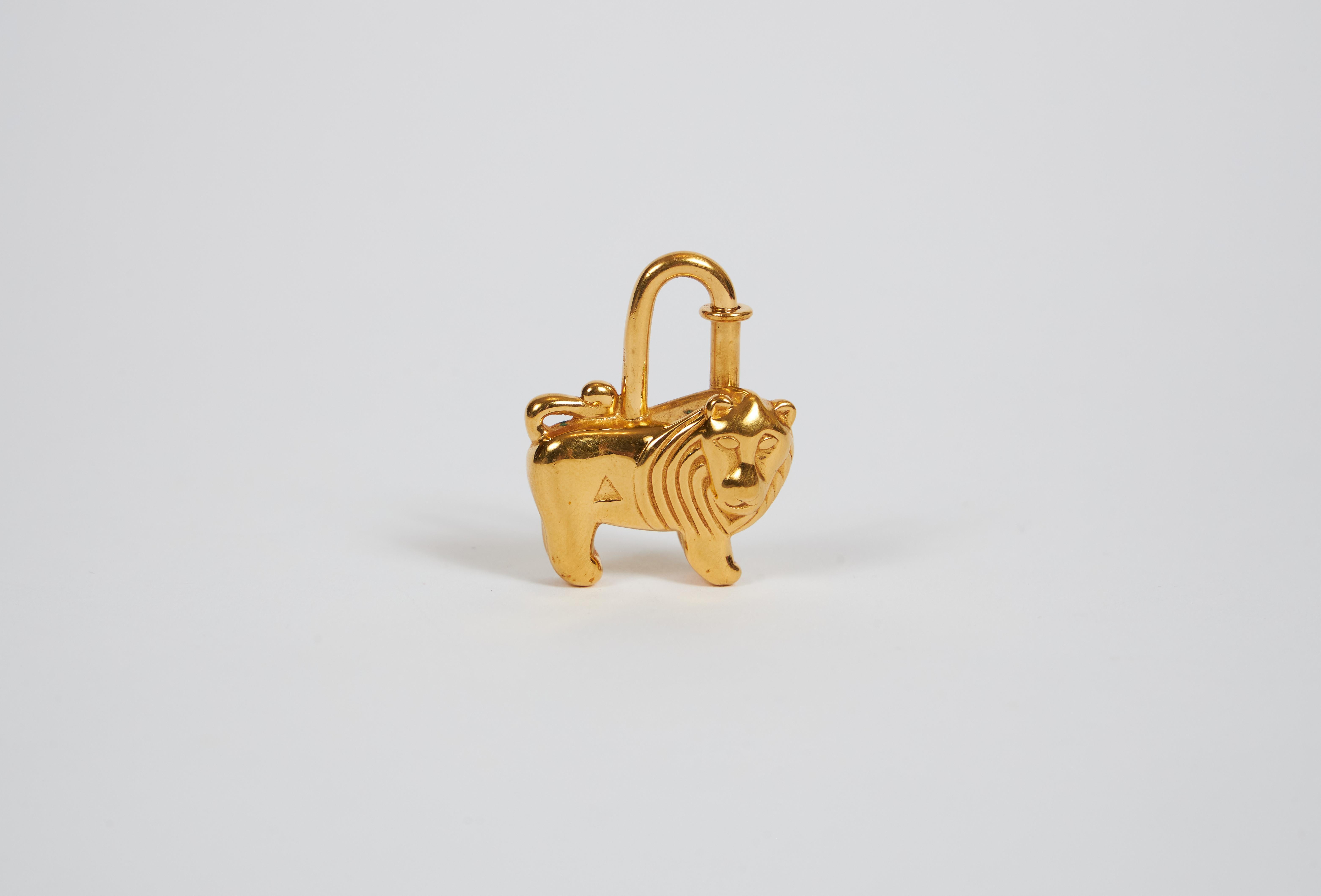 1997 Authentic Hermes Cadena lock lion gold charm. Excellent condition with original box.