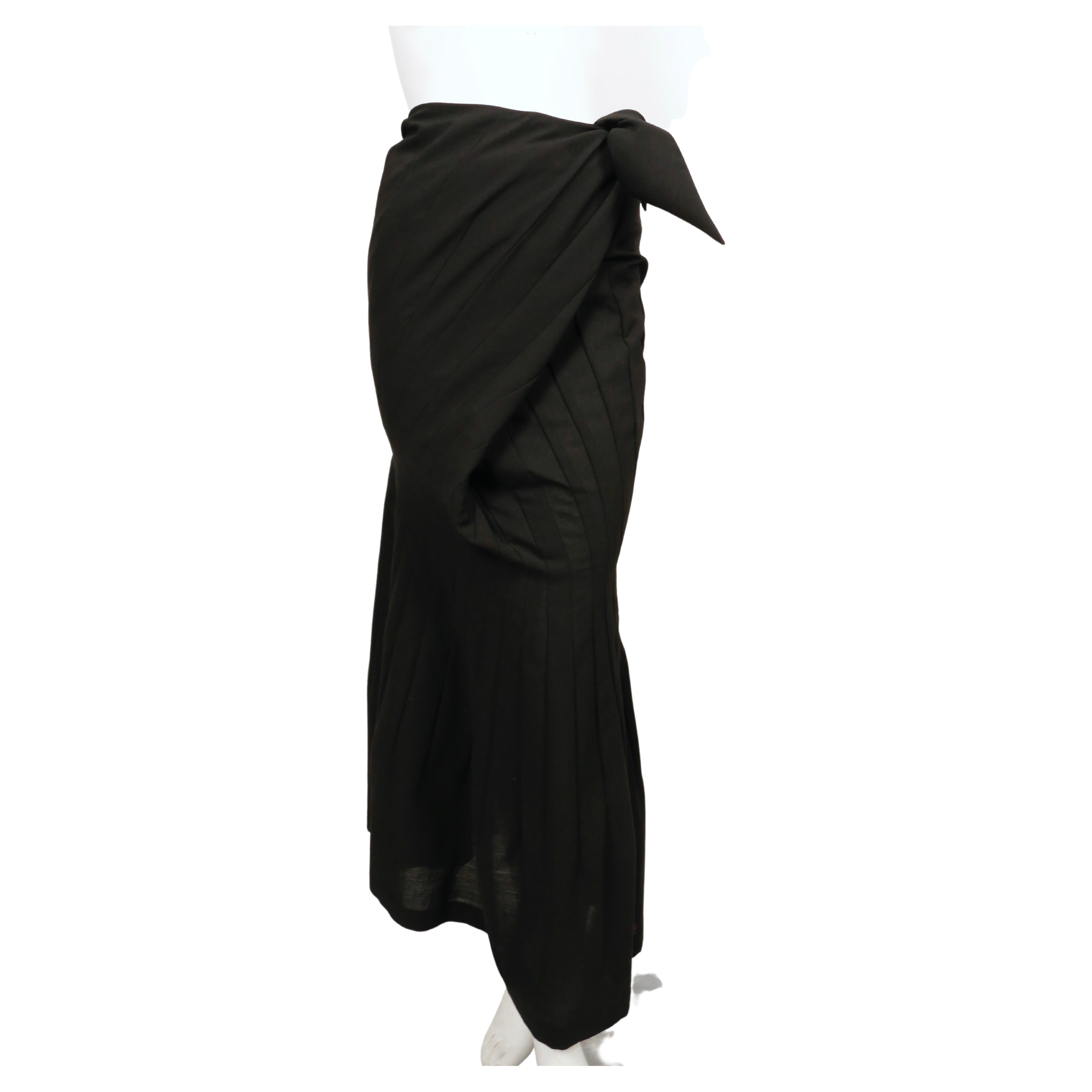 Jet-black paneled skirt with wrap closure designed by Junya Watanabe for Comme Des Garcons as seen on spring 1997 runway in several colors including black. Very flattering shape. No size indicated but it fits a S. Approximate measurements: waist 26