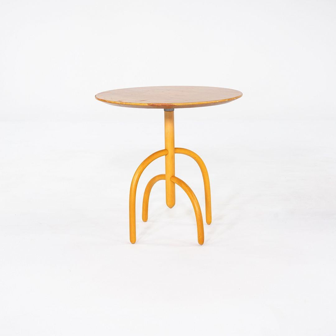 This is a Saguaro Cactus Side table, initially designed by Lawrence Laske for Knoll in 1993. This particular example dates to 1997. The piece is made of Birch, and has an interesting base that resembles rounded branches. There is a metal Knoll
