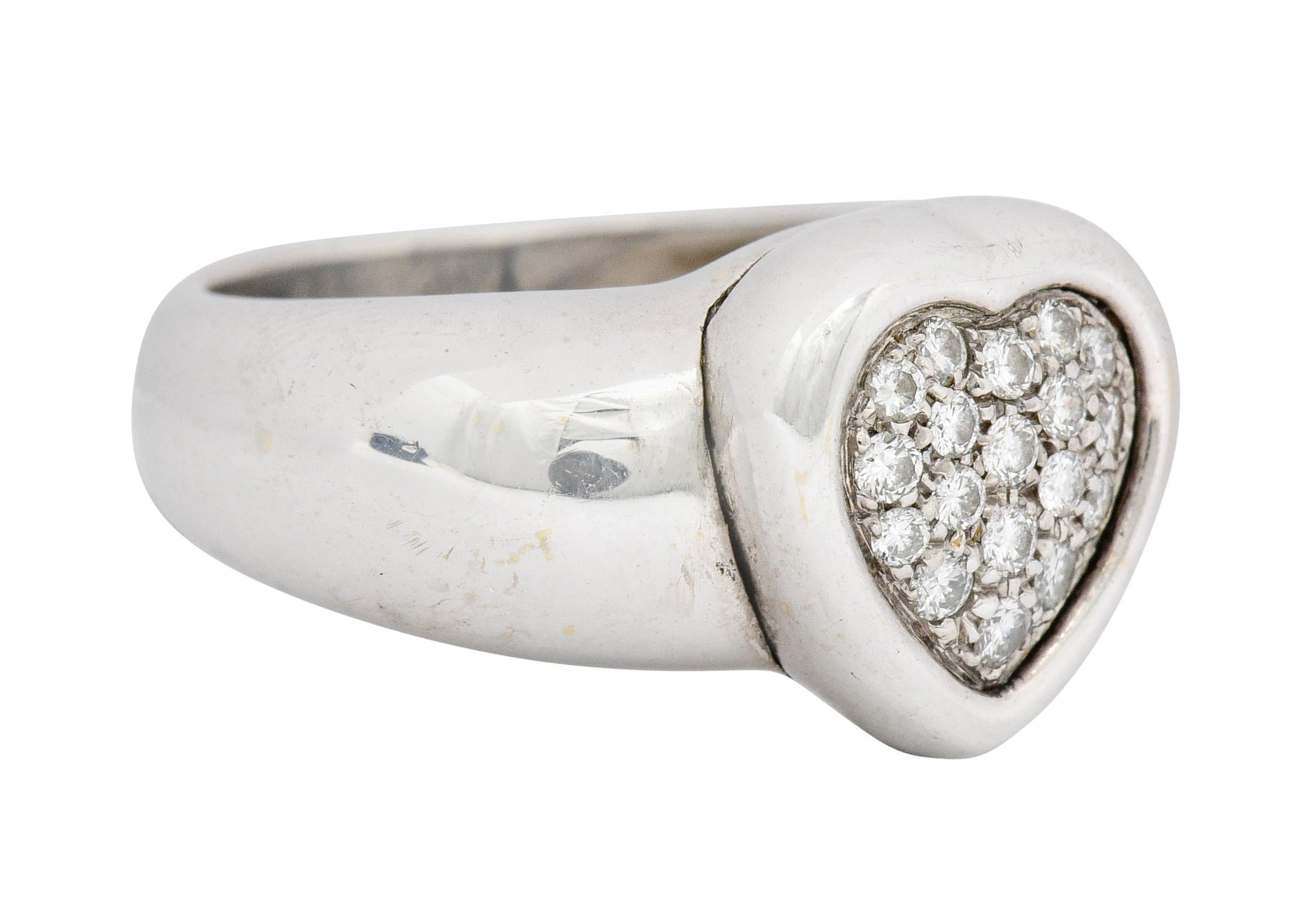 Puffed band ring centering a sweet heart design

Pavé set with round brilliant cut diamonds weighing approximately 0.36 carat, G/H color with VS clarity

Tested as 18 karat gold

Fully signed Piaget and numbered

Ring Size: 7 & sizable

Measures: