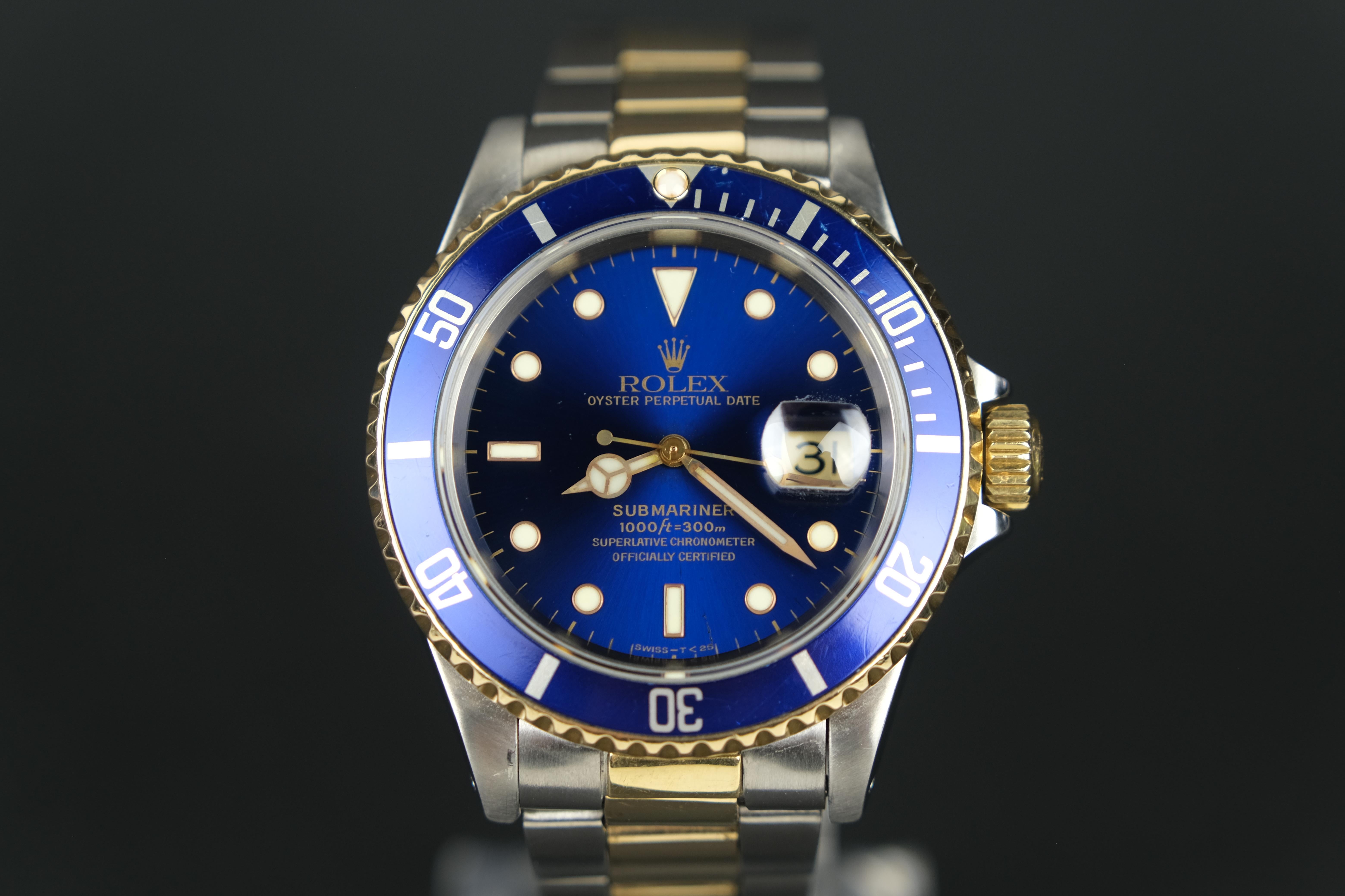 A 1997 Rolex Sabmariner Date 18K Gold and Stainless Steel automatic wristwatch. A classic watch that has the heritage of being a divers watch and the history of the Oyster Perpetual that combines to create a watch with an 18K yellow gold