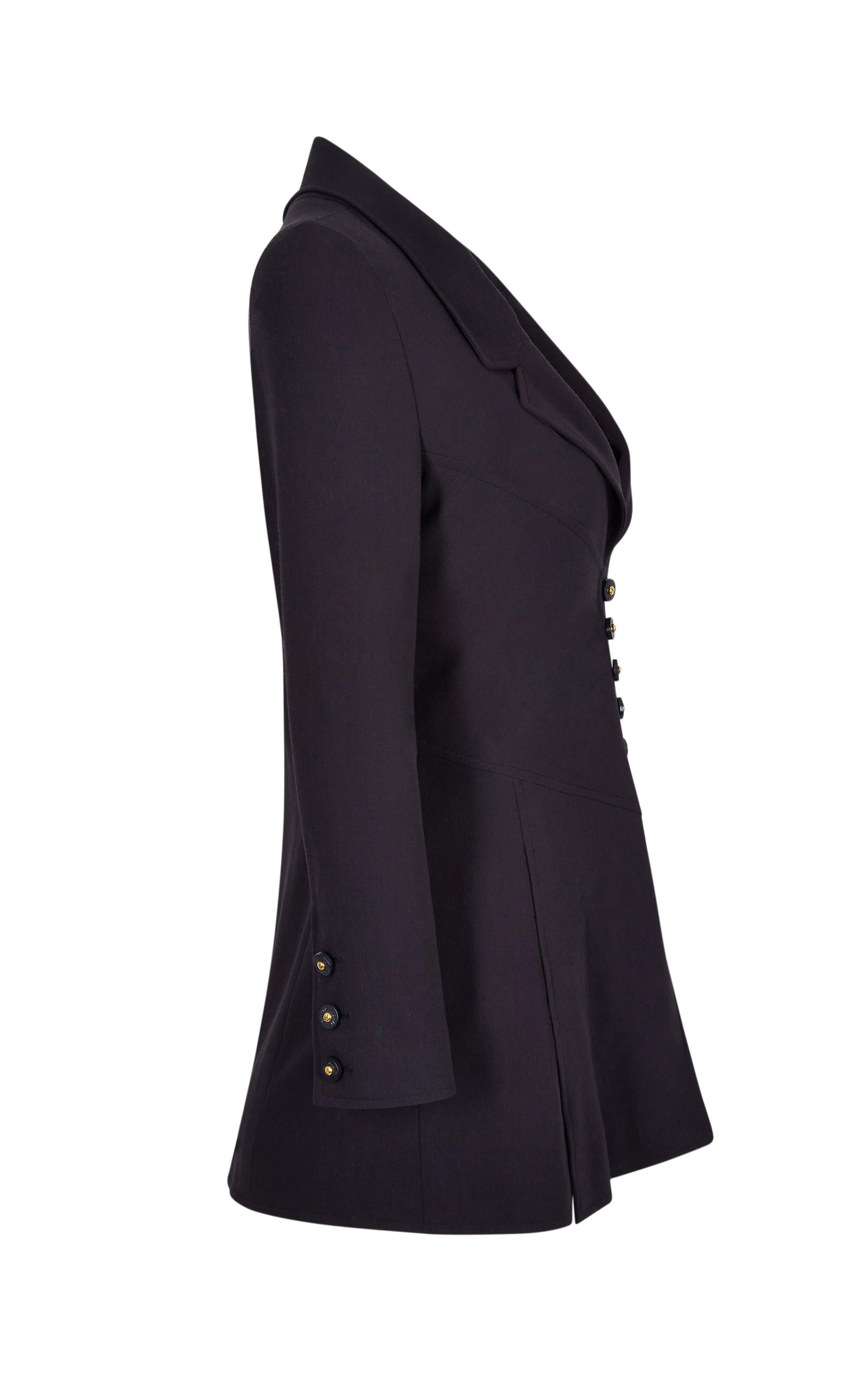 This striking Chanel black fine wool blazer is from the 1997 Spring collection and is in impeccable vintage condition with a sharp, elegant line. It has a lapel collar that fastens into a plunging V neckline above the central button stand and