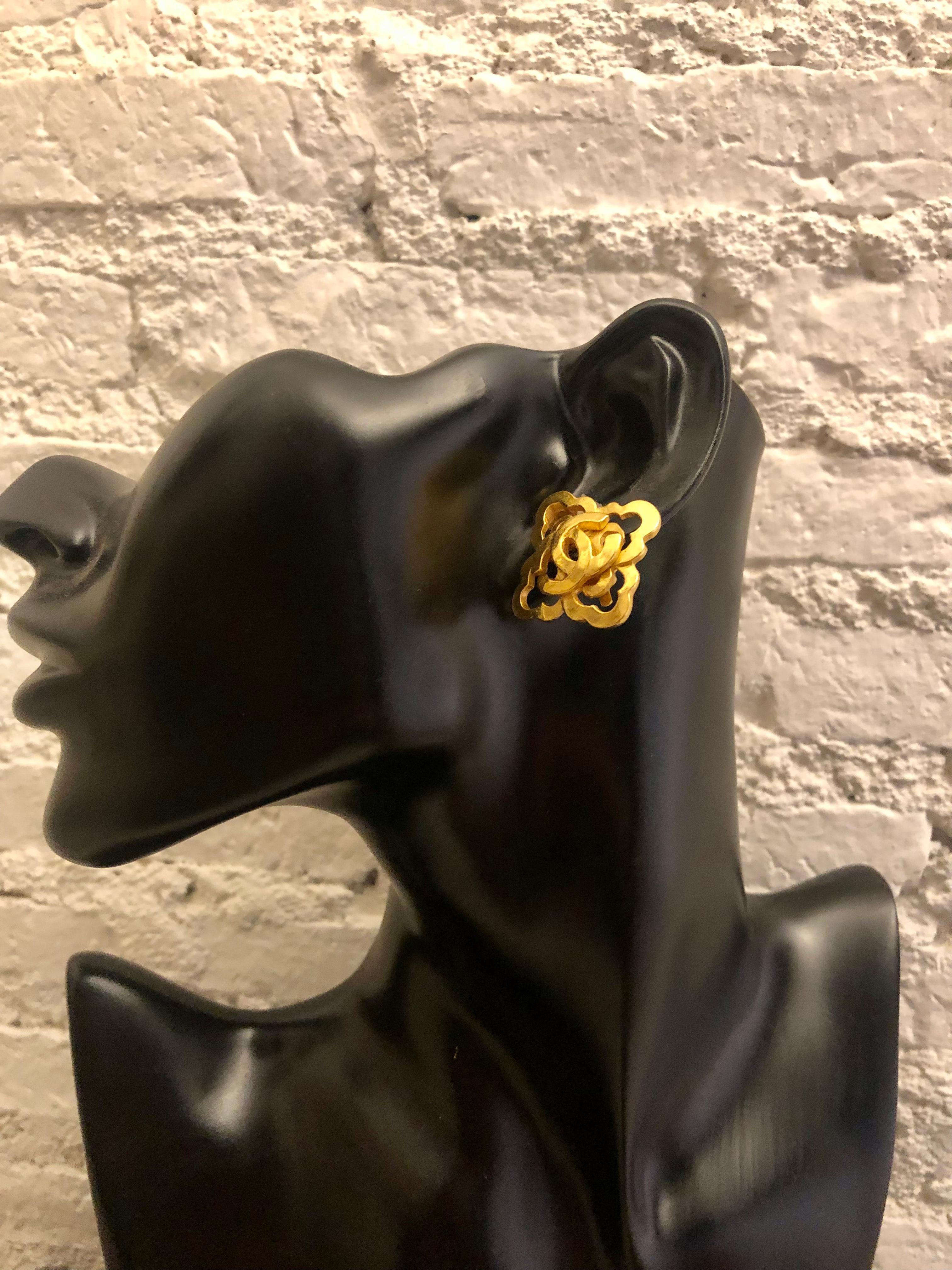 These Vintage CHANEL clip-on earrings are crafted of gold plated cloverleaf adorned with CC logo in the center. Stamped CHANEL 97A made in France. Diameter measures approximately 2.8 cm. Come with box. 

Condition - Excellent vintage condition with
