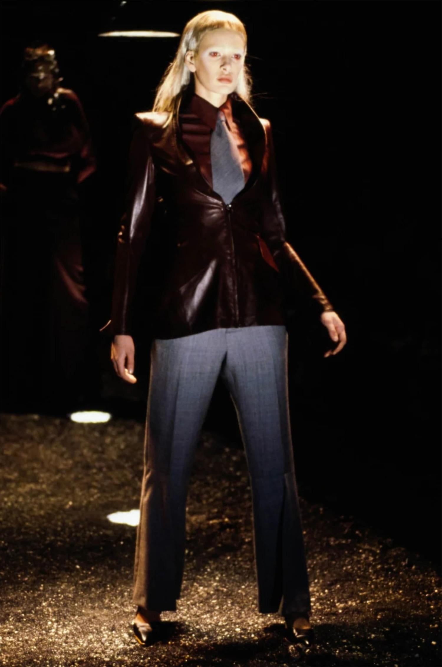 An incredibly chic and highly coveted Alexander McQueen black sculpted leather jacket dating back to his well documented 1998 fall/winter 'Joan' collection. This highly stylized yet timeless jacket, look #16 on the runway, is a perfect example of