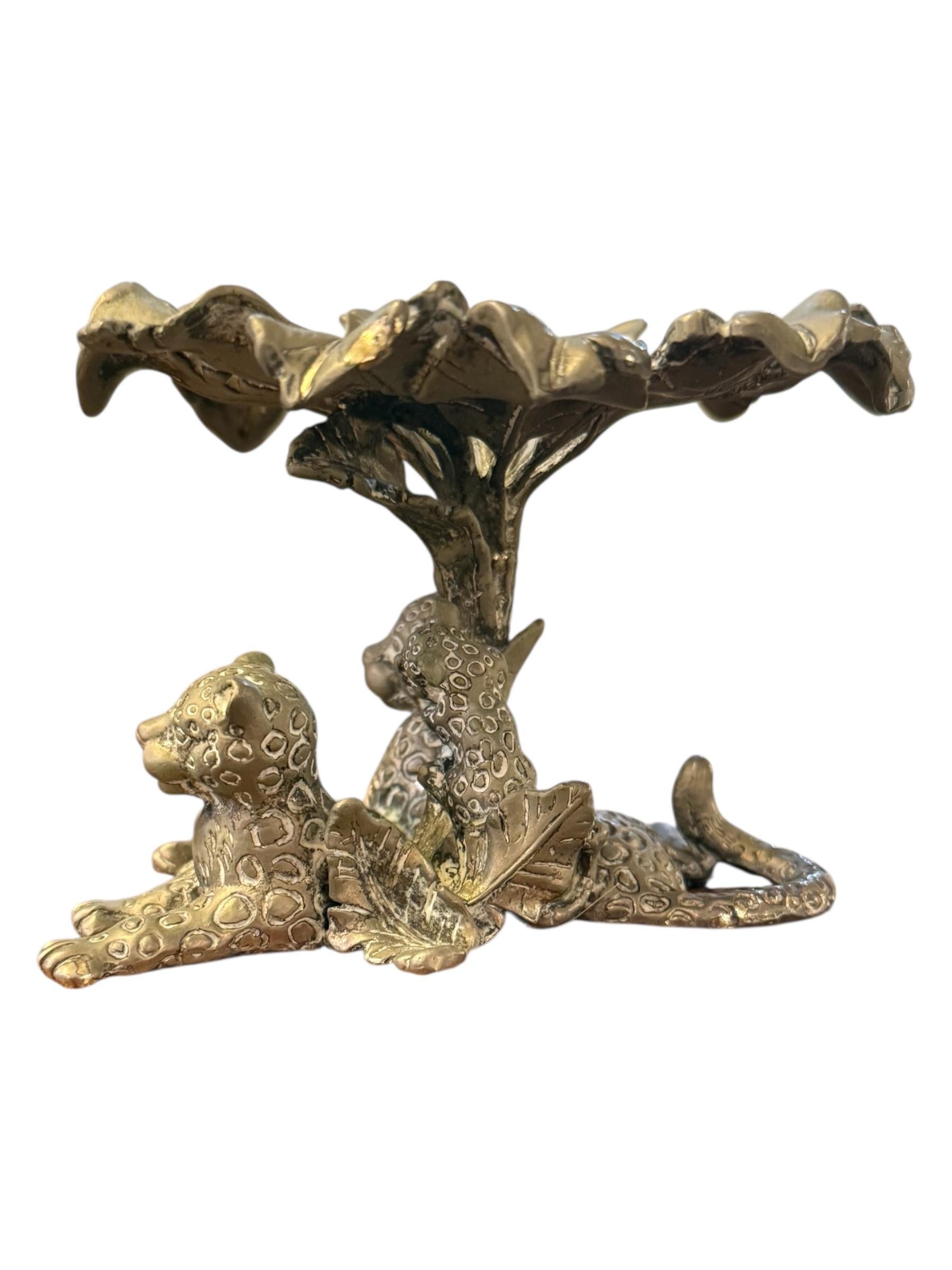 Bring a touch of the wild into your home with this stunning 1998 Arthur Court Leopard and Cub Sculpture/Candleholder. Exquisitely cast in Arthur Court’s signature aluminum alloy, this rare collectible piece captures the raw beauty and elegance of a