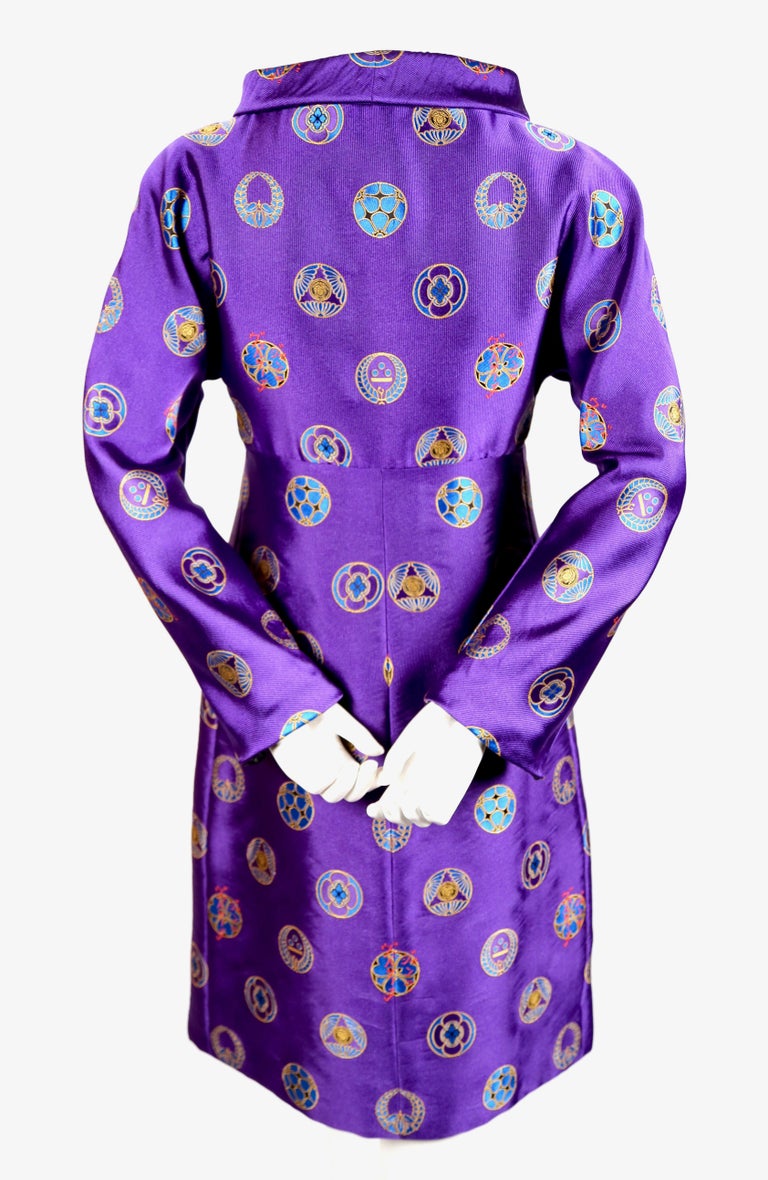 Rich purple silk brocade coat with Asian motif and Medusa medallions from Versace Atelier dating to 1998 which was Gianni Versace's last runway show. Impeccable quality throughout. Coat is lined in contrasting black fabric and looks just as
