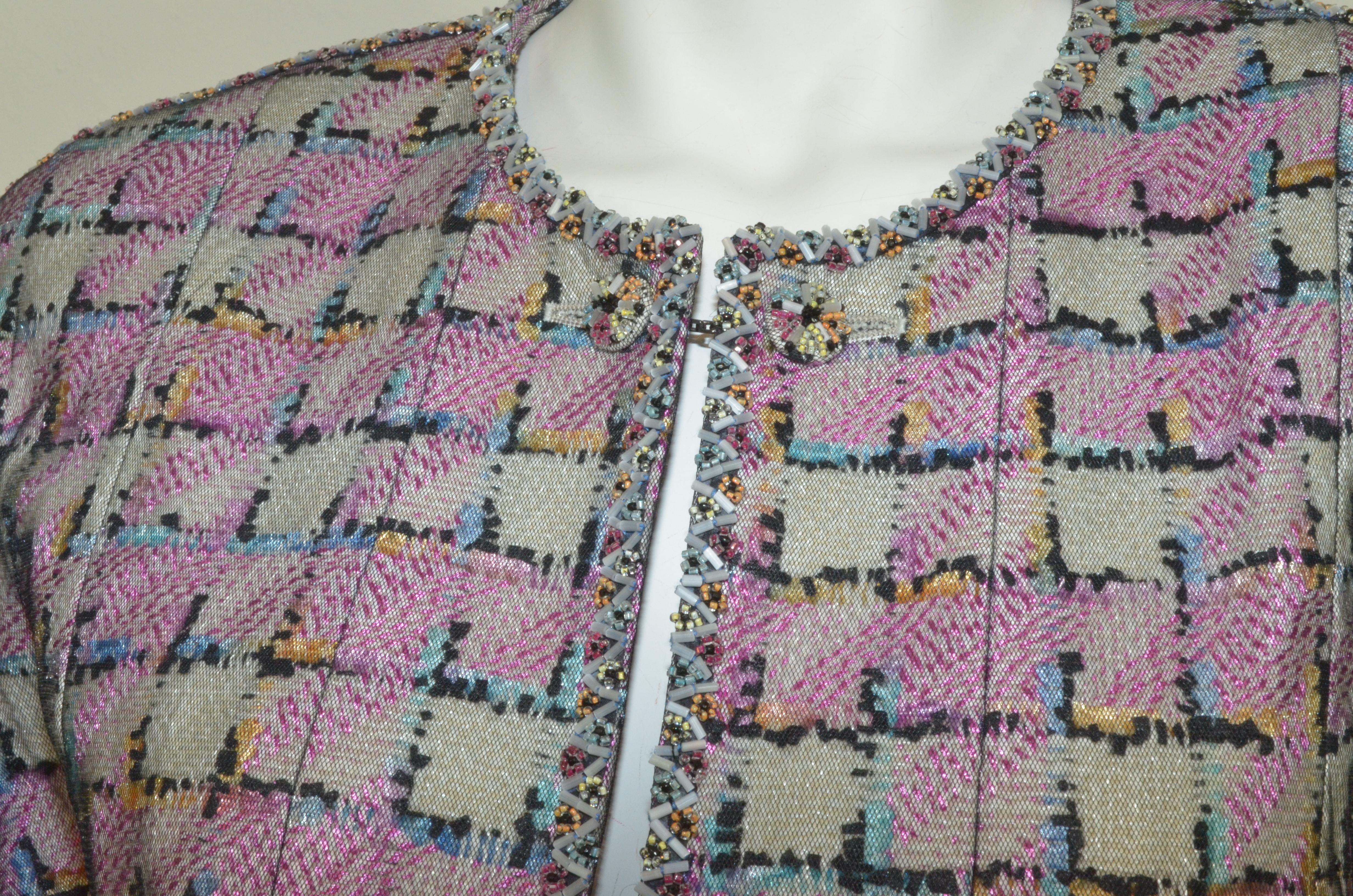 Vintage Chanel jacket features a multicolored design with a black mesh overlay. Jacket has a flower bead-embellished trim, chain button closure, and full lining. Labeled size 44, made in France.

Measurements:

Bust – 40”
Sleeves – 25”
Length – 23”