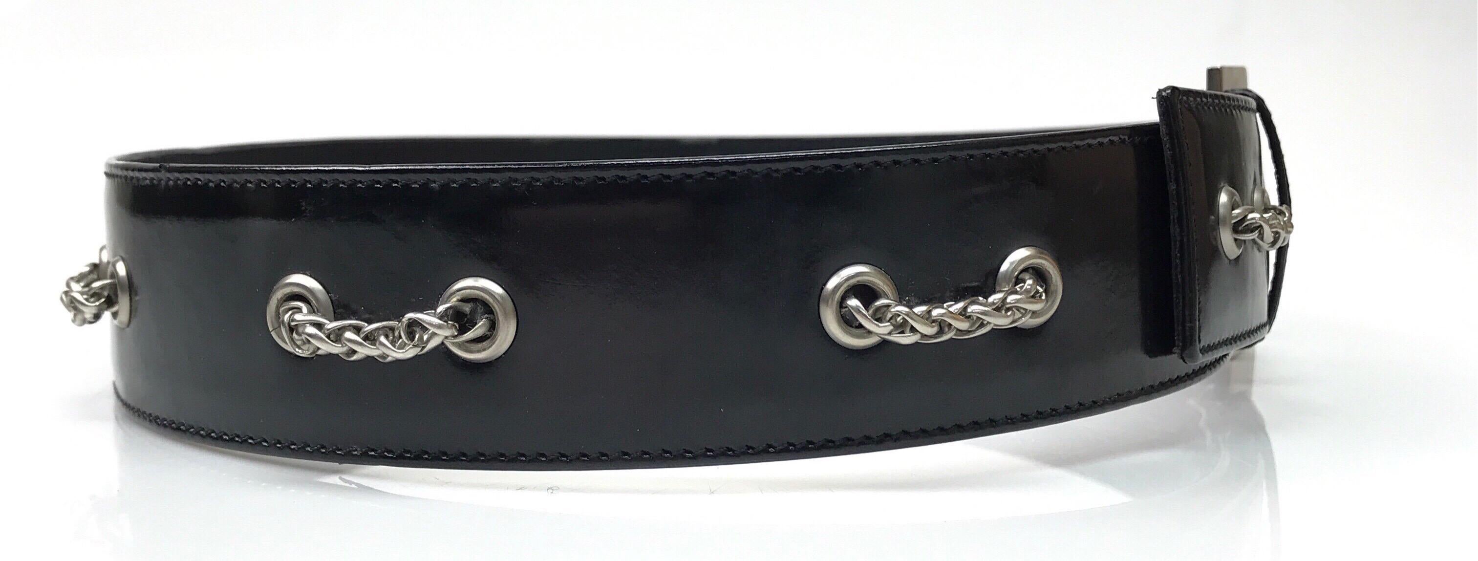 1998 Chanel Black Patent Belt w/ Silver Hardware-28. This amazing Chanel belt is in good condition. It shows visible signs of use with slight discoloration on the outside and creasing of the inside of the belt. It is made of black patent leather on