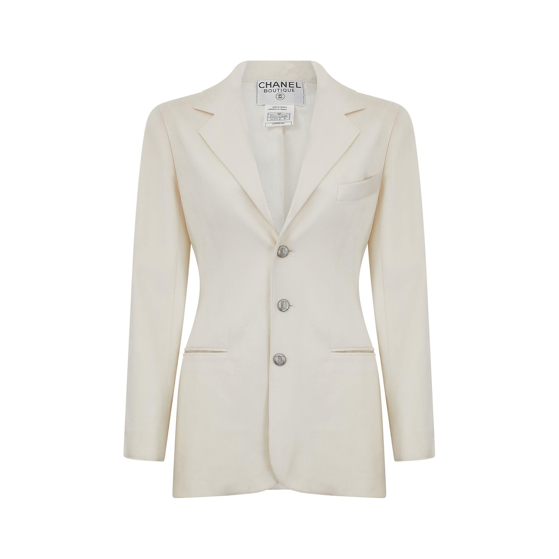 This 1990s Chanel blazer jacket is made in France and cut from a beautifully soft cream wool fabric.  It features a sharp collar and lapel detail, and fastens at the front with three molded silver buttons, all adorned with the classic Chanel double