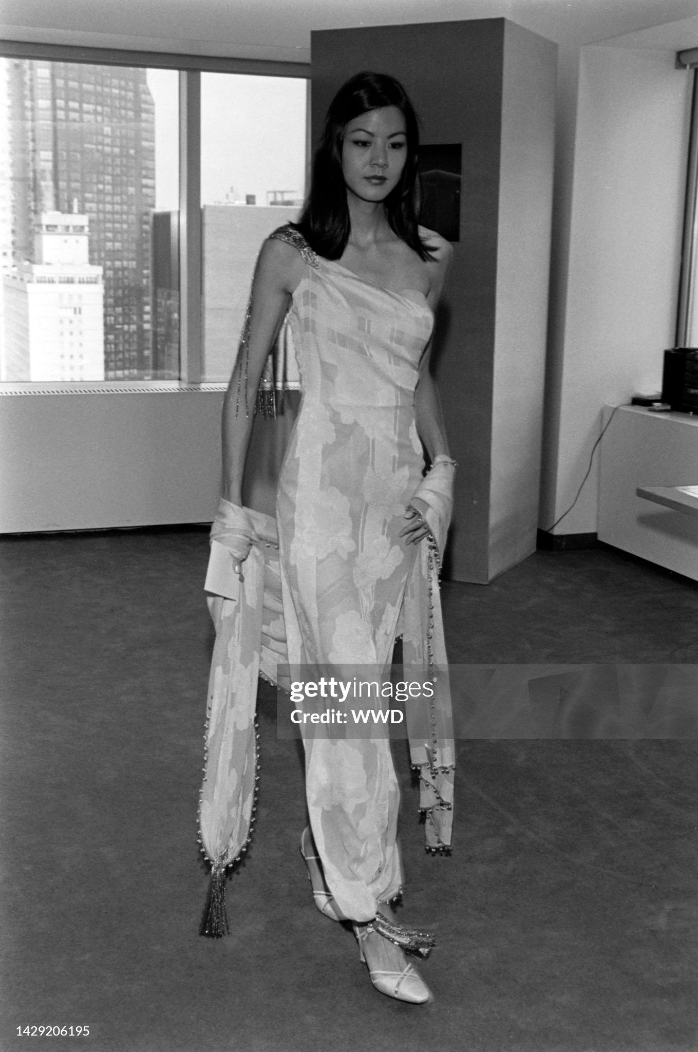 A totally enchanting and incredibly rare Christian Dior ivory floral silk asymmetric bias-cut gown dating back to John Galliano's 1998 resort collection. We were thrilled to find a picture of the dress gliding down the runway. John Galliano is