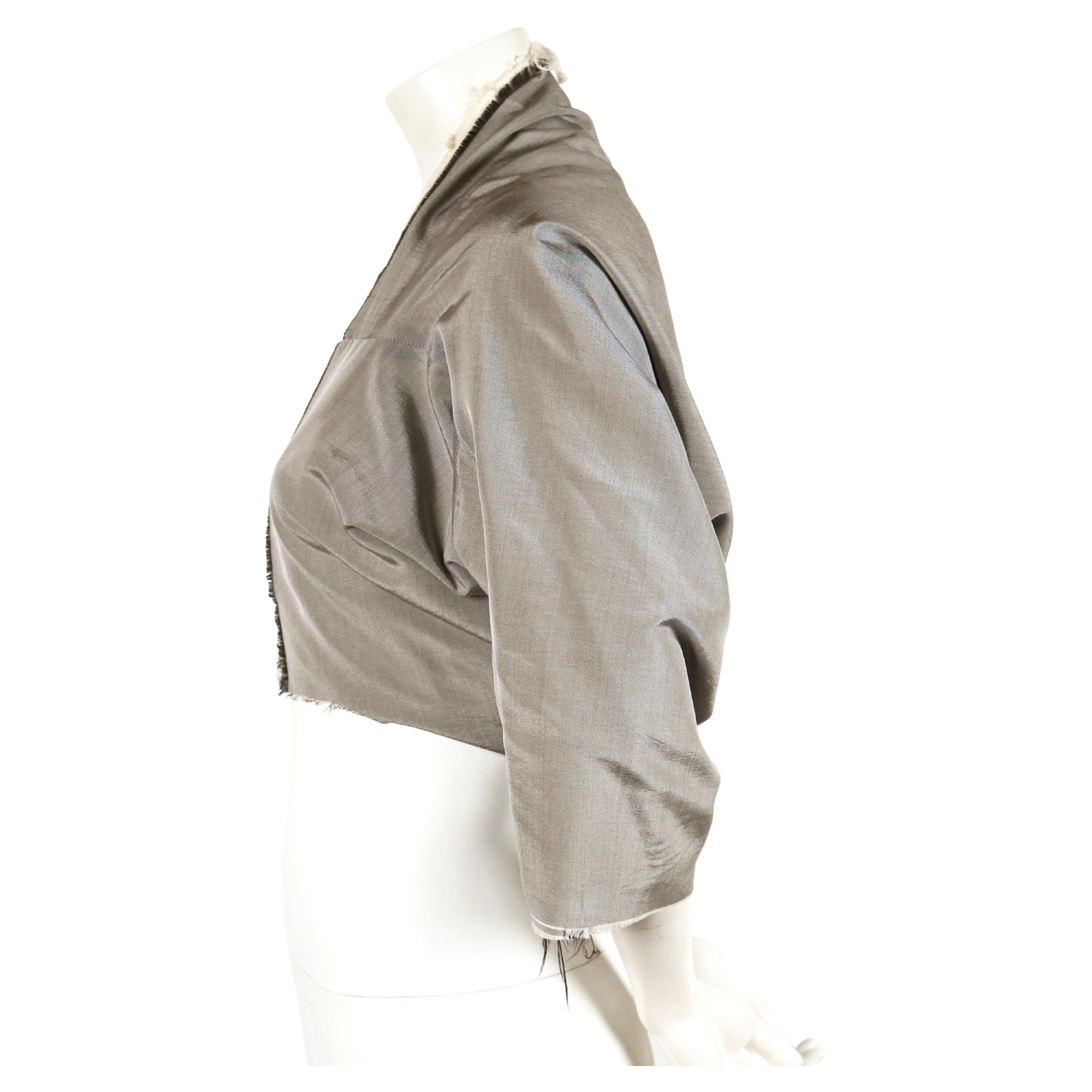 Iridescent grey shrug designed by Rei Kawakubo for Comme Des Garcons dating to fall of 1998. Size 'M', however this best fits a size XS or S. Raw edges. Open closure. Made in Japan. Very good condition. 