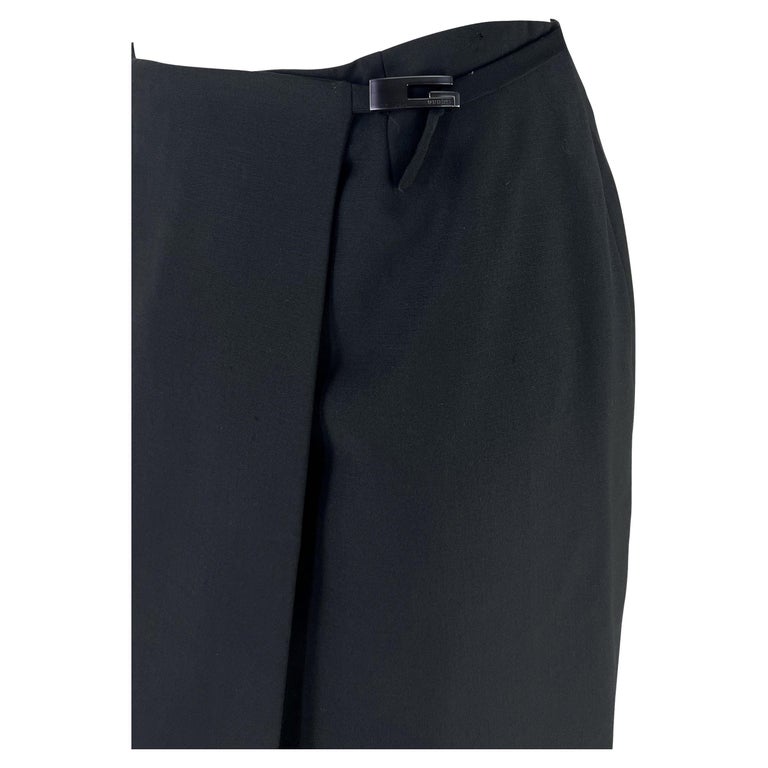 TheRealList presents: a fabulous black Gucci skirt, designed by Tom Ford. From 1998, this wrap skirt features the season's famous square 'G' Gucci buckle at the hip that is secured with a strand of fabric. Similar to the 1997 Gucci wrap skirt seen