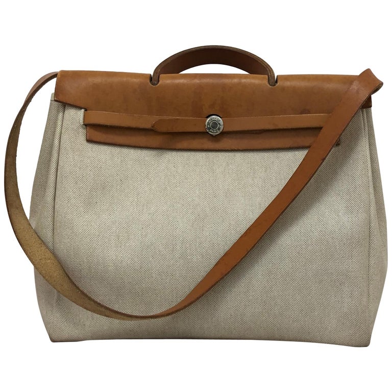 https://a.1stdibscdn.com/1998-hermes-large-beige-canvas-and-tan-leather-herbag-w-canvas-protector-for-sale/1121189/v_106570821603783321334/10657082_master.jpg?width=768