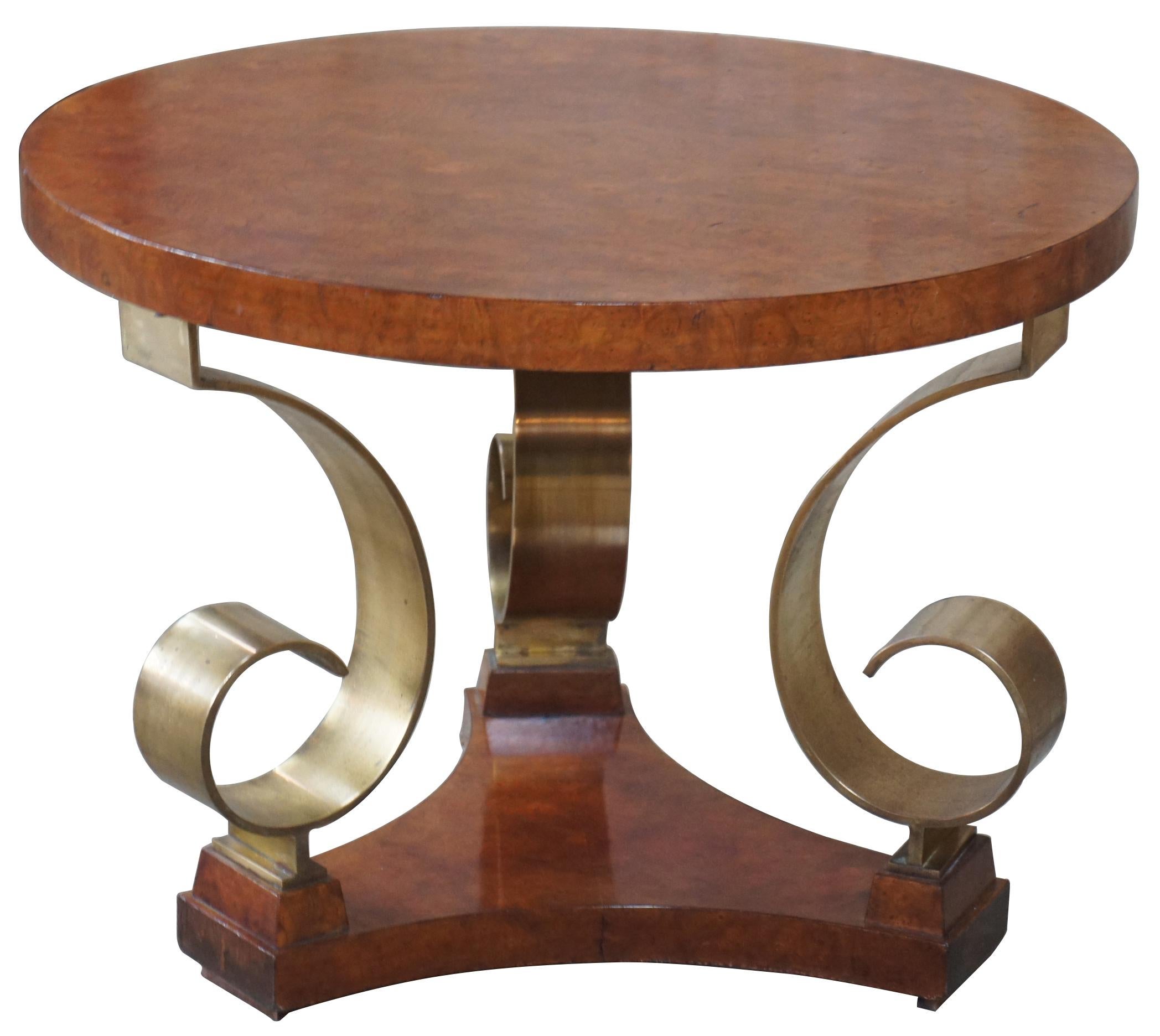 Late 20th century olive burl and scrolled brass side table. Featuers a round top supported by three elegent brass scrolls over a tripod form base. Signed along underside.
  