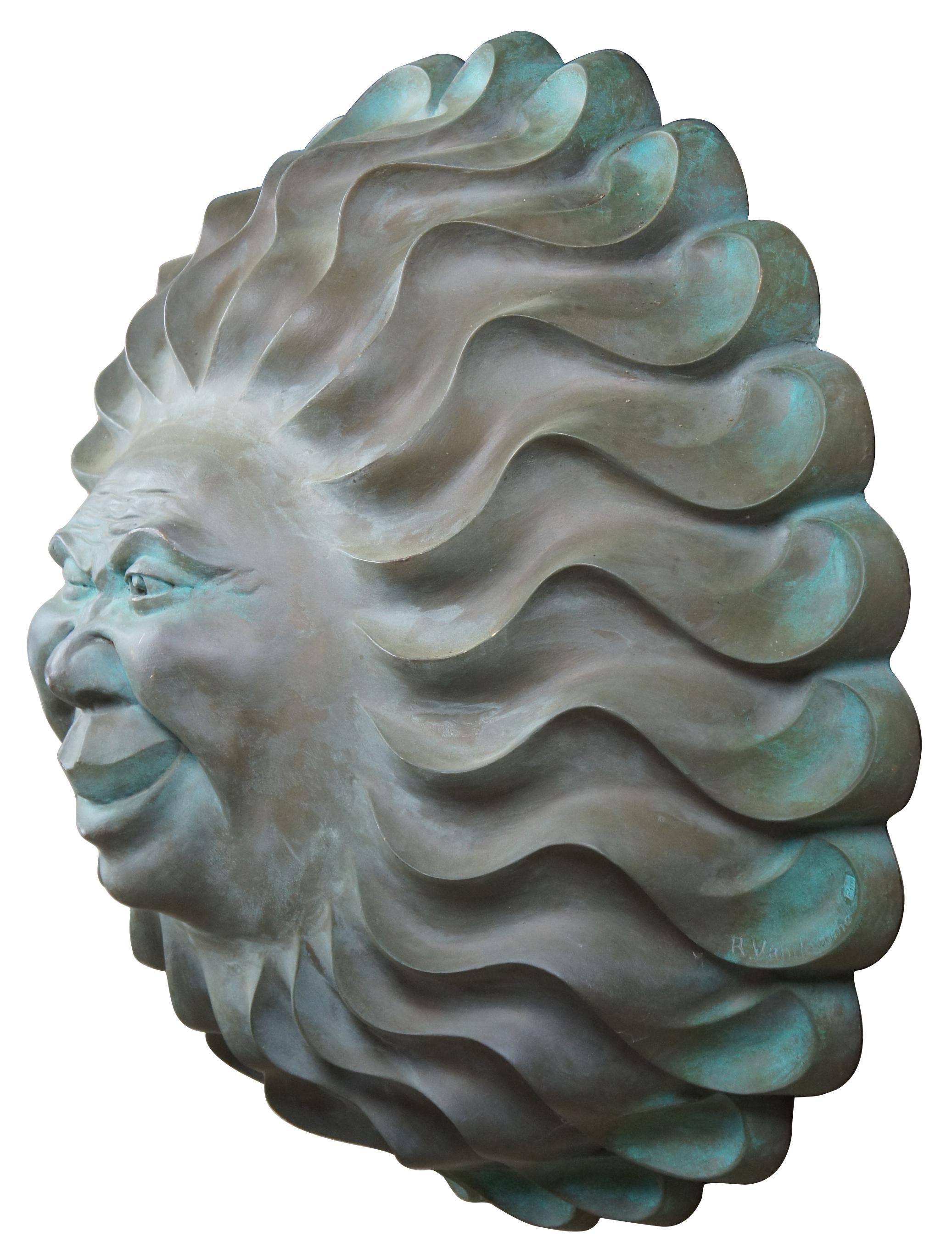 Late 20th century R. Vandamme figural sun face wall art sculpture. Features a large sunburst or starburst shaped plaque featuring a winking and smiling sun or moon faced man. Great for indoor or outdoor use. R. Vandamme was well known for his moon