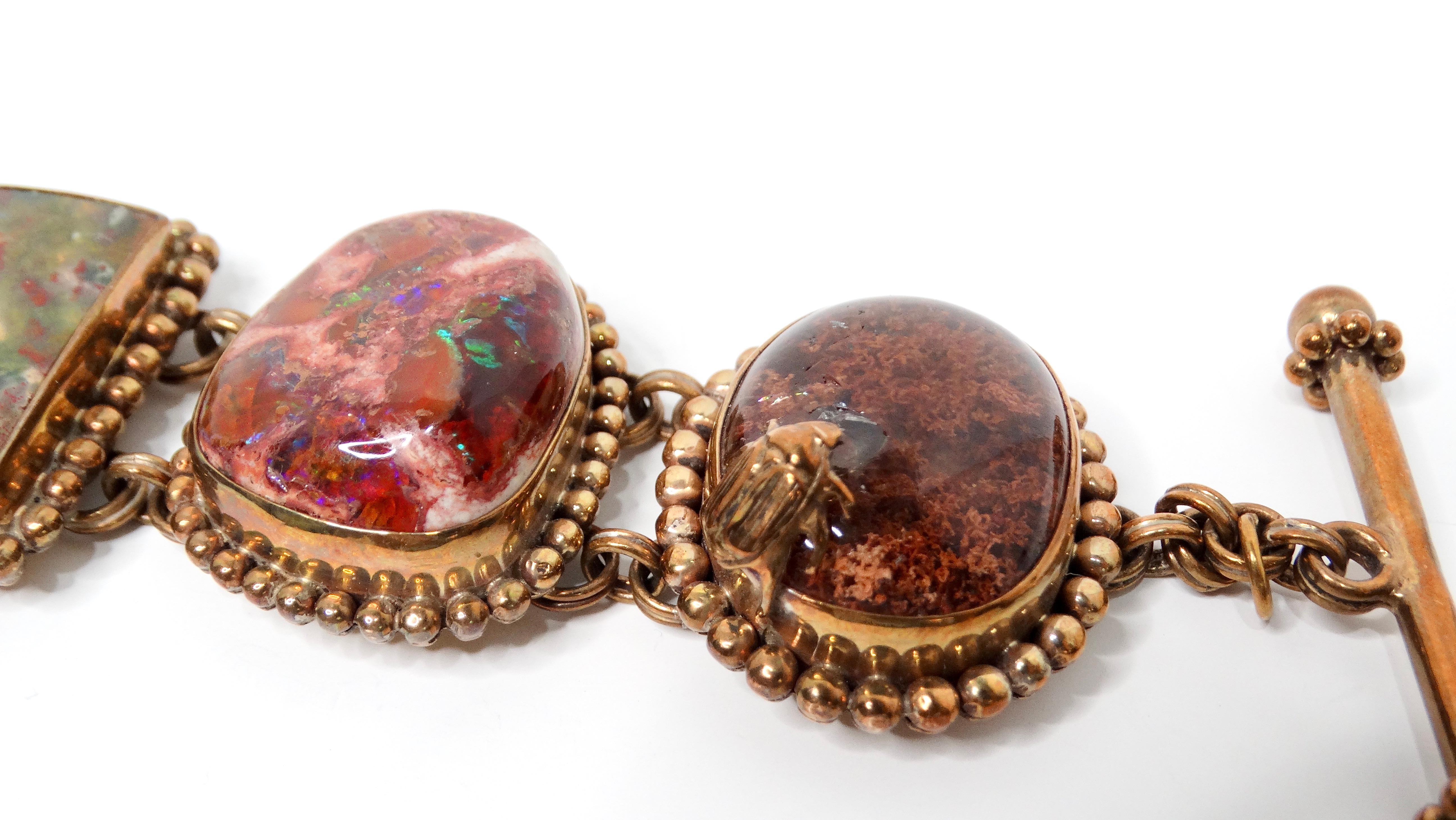 The 1998 Stephen Dweck Natural Gemstone Brass & Sterling Silver Toggle Bracelet effortlessly showcases the designer's love for nature through its exquisite craftsmanship. This stunning piece features rich, natural gemstones with a unique small