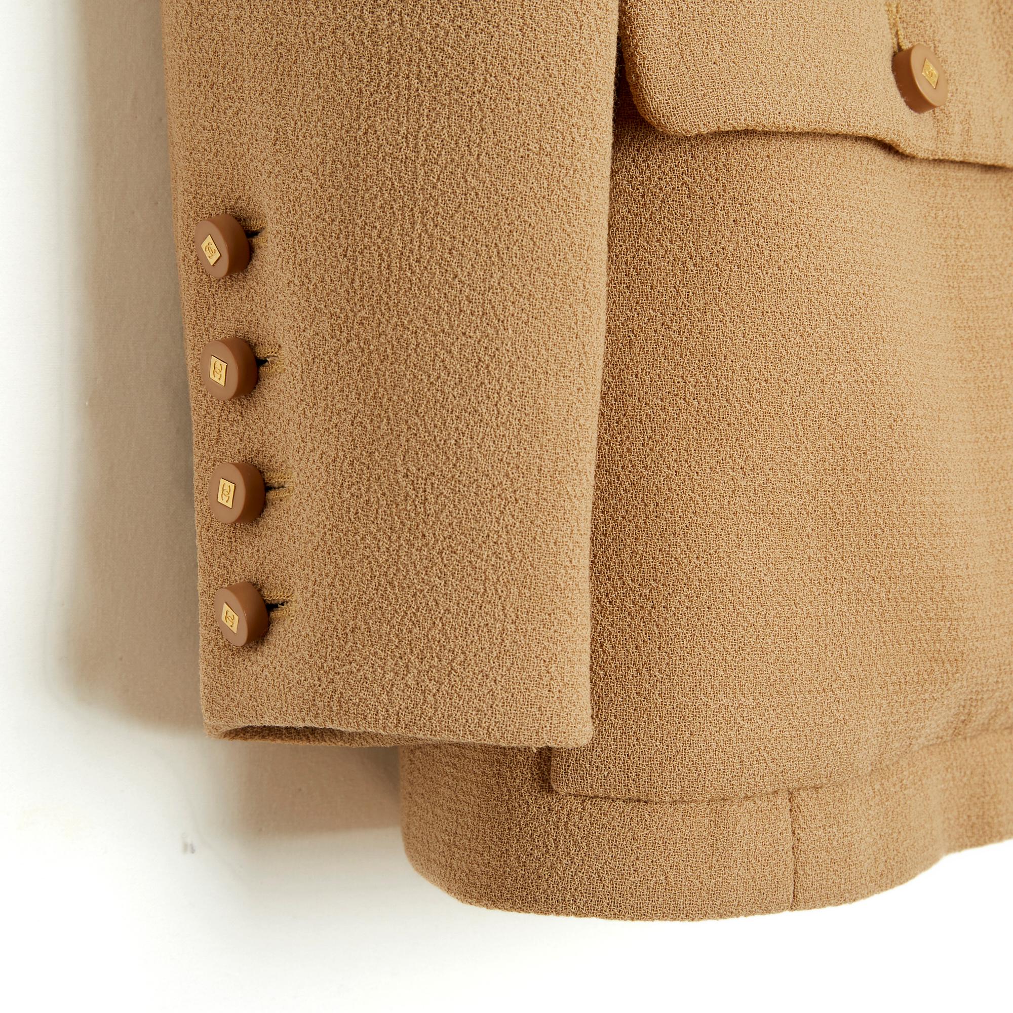 Chanel jacket from the Fall Winter 1998 collection in thick camel beige wool crepe, small high collar closed in front with a series of 15 gold metal hooks, 4 buttoned patch pockets on the chest and hips, long sleeves closed with 3 CC logo buttons ,