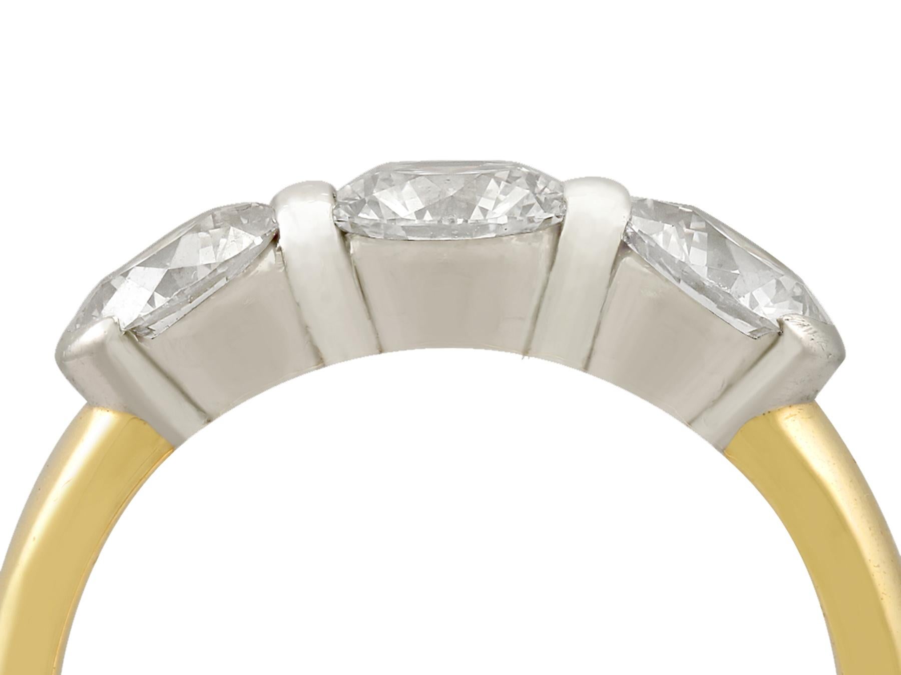 A stunning contemporary Tiffany & Co 2.13 carat diamond and 18 karat yellow gold, platinum set trilogy ring; part of our diverse diamond jewelry and estate jewelry collections.

This stunning, fine and impressive Tiffany & Co three stone diamond