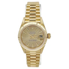 1999 26mm Rolex Presidential 18K Gold with Champagne Dial and Fluted Bezel.