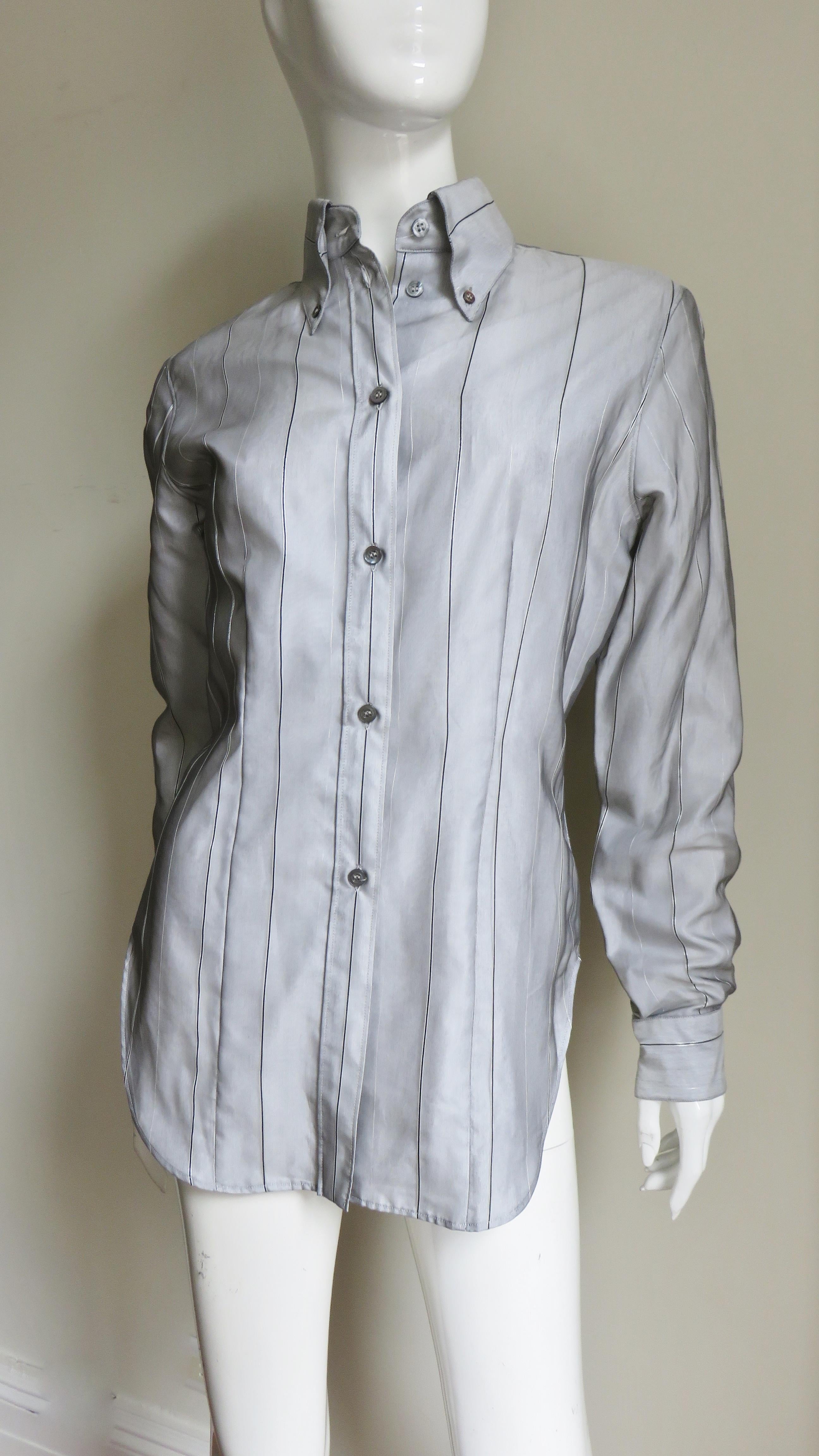 A fabulous 2 piece set by Alexander McQueen consisting of a long jacket and shirt in grey sheer silk with fine black and silver stripes over white.  The shirt has a grey mother of pearl button down collar, button front, long button cuffs sleeves