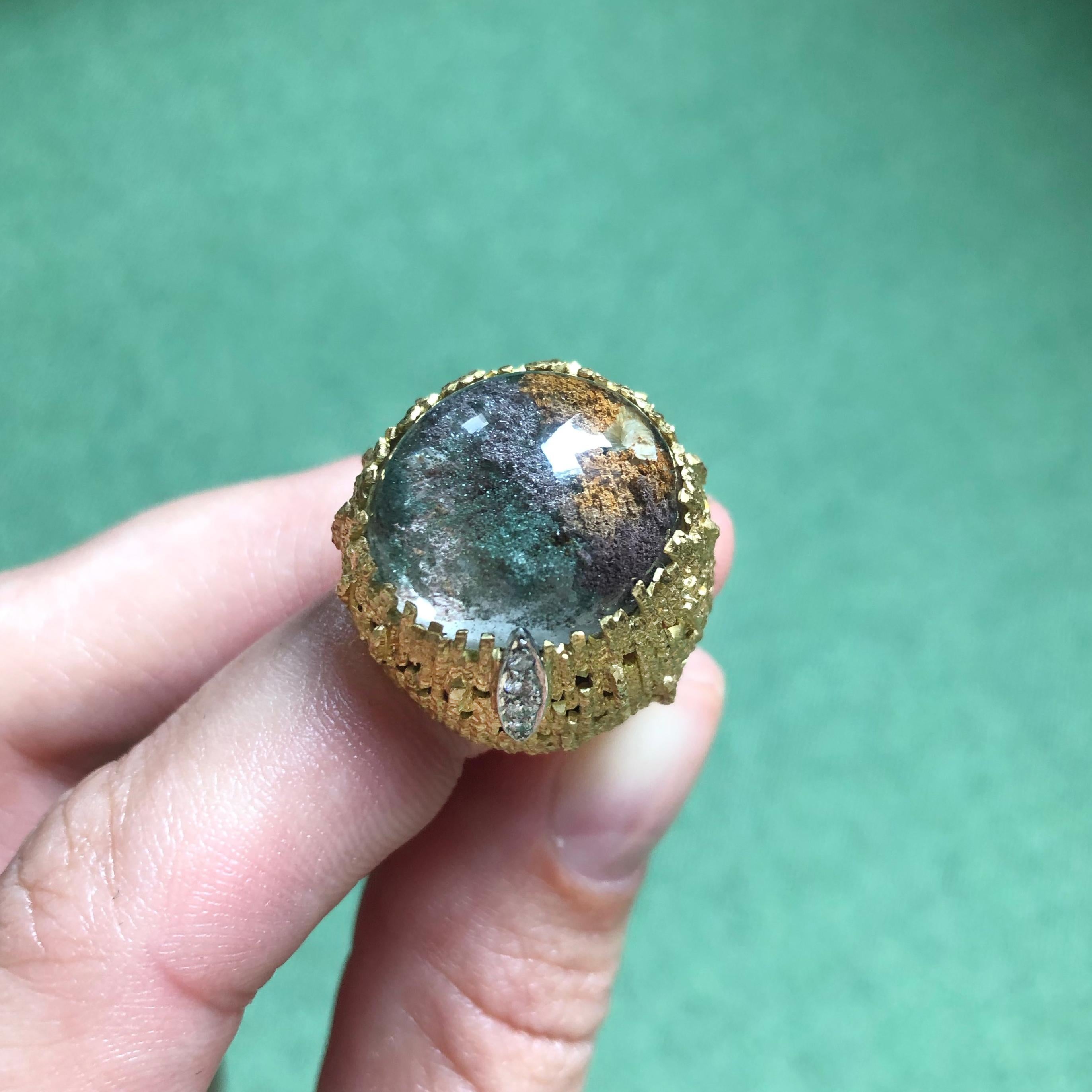A dendritic agate, diamond and 18 karat textured gold ring, by British modern designer Andrew Grima, 1999.
Signed Grima. Stamped with maker's mark, 750 and London assay marks. 
With original maker's case, original drawings signed by Andrew Grima,