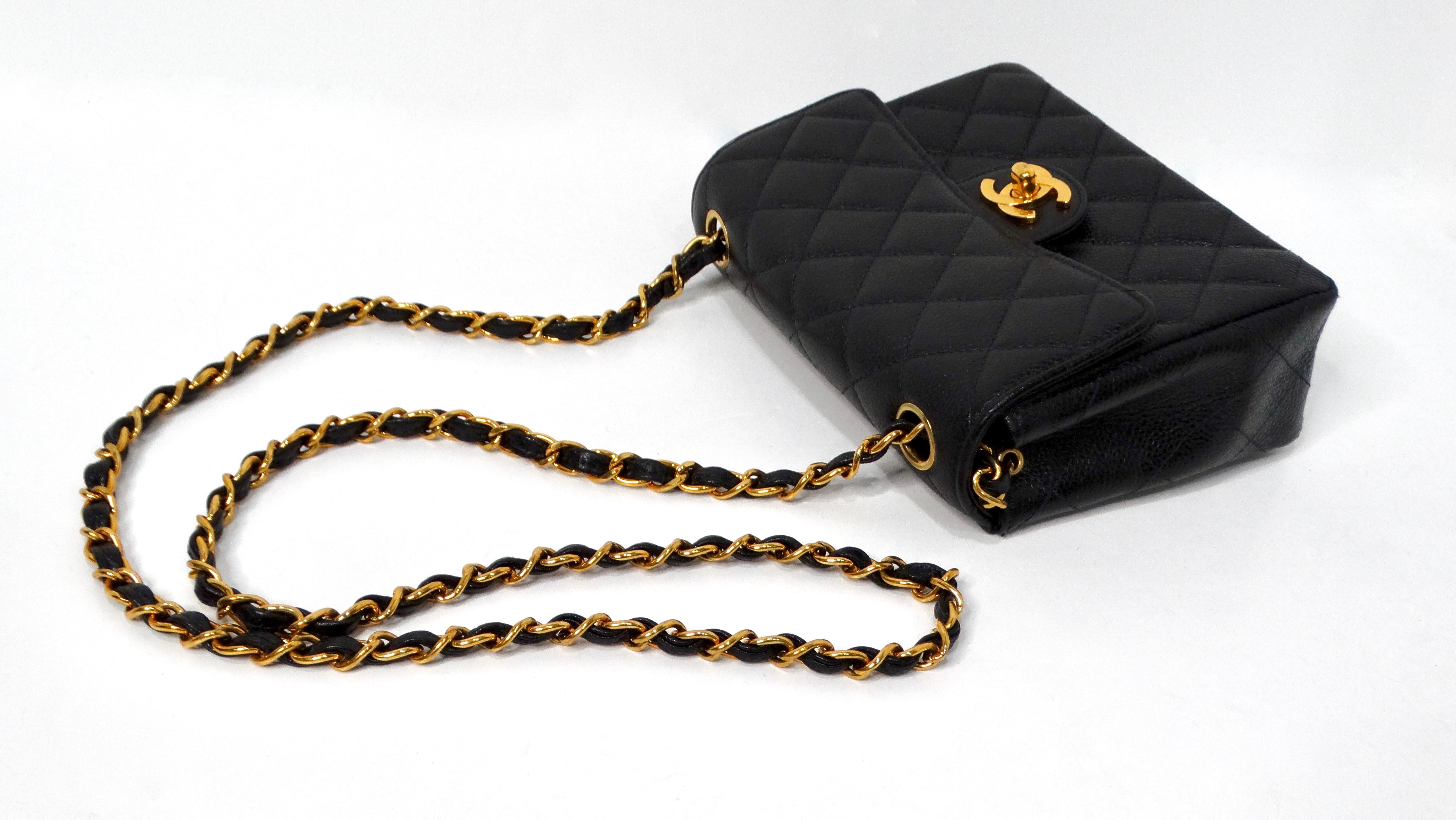 The 1999 Black Chanel Square Mini Caviar Leather Flap Bag is a timeless luxury accessory that epitomizes elegance and sophistication. Crafted from durable caviar leather, this bag features a distinctive Turlock CC logo lock complemented by gold