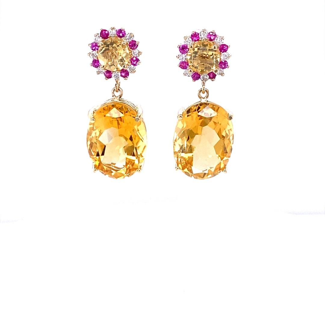 19.99 Carat Citrine Pink Sapphire Diamond Earrings 14 Karat Yellow Gold

These lovely earrings have 2 vibrant Oval Cut Citrine Quartz that weigh 17.57 carats.  There are also 2 Round Cut Citrines on the top of the earrings that weigh 1.62 carats and