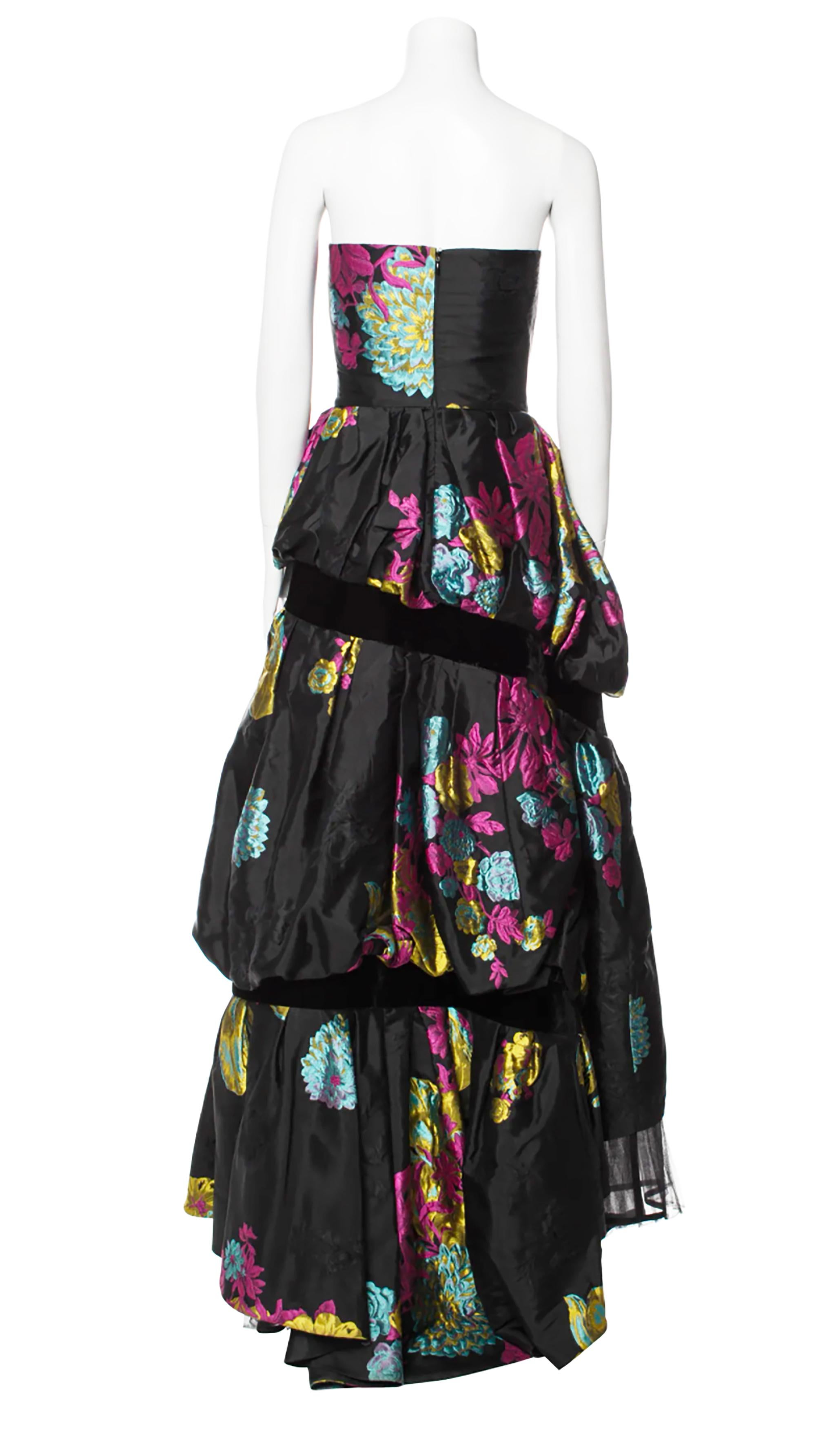 Fall/Winter 1999 Collection Christian Lacroix Strapless Evening Gown
Black With Floral Print and Embroidered Accents
Concealed Zip Closure at Back

Fabric: 64% Acetate, 23% Silk, 13% Wool

Condition: Excellent

Bust: 30.5