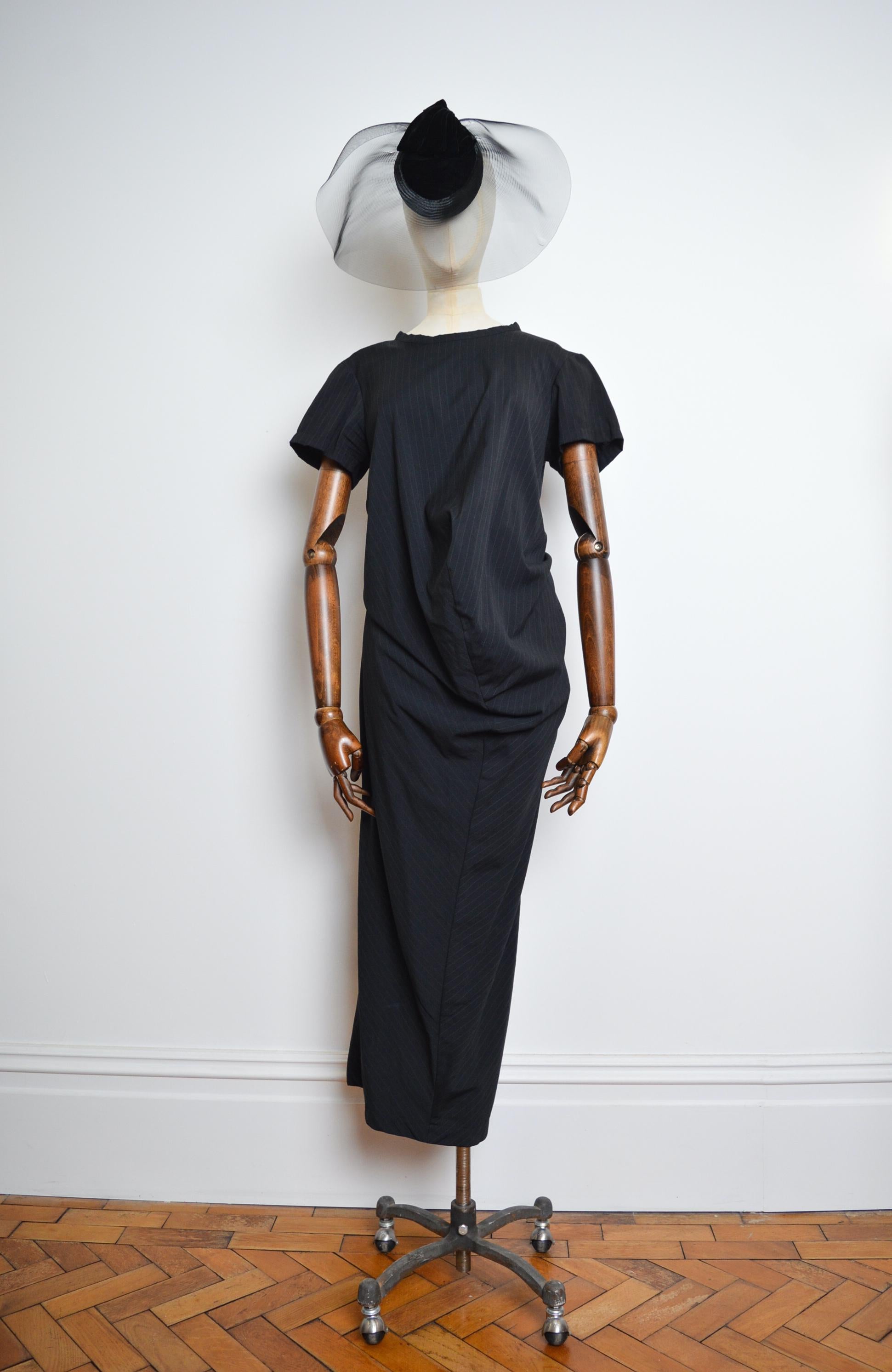 Superb ORIGINAL 1999, Avant Guard Pinstriped dress by COMME DES GARÇONS, elegantly constructed in a Charcoal Wool cloth.   

MADE IN JAPAN.   

The Garment can be moved and contorted to create multiple shapes and silhouettes.

Measurements provided