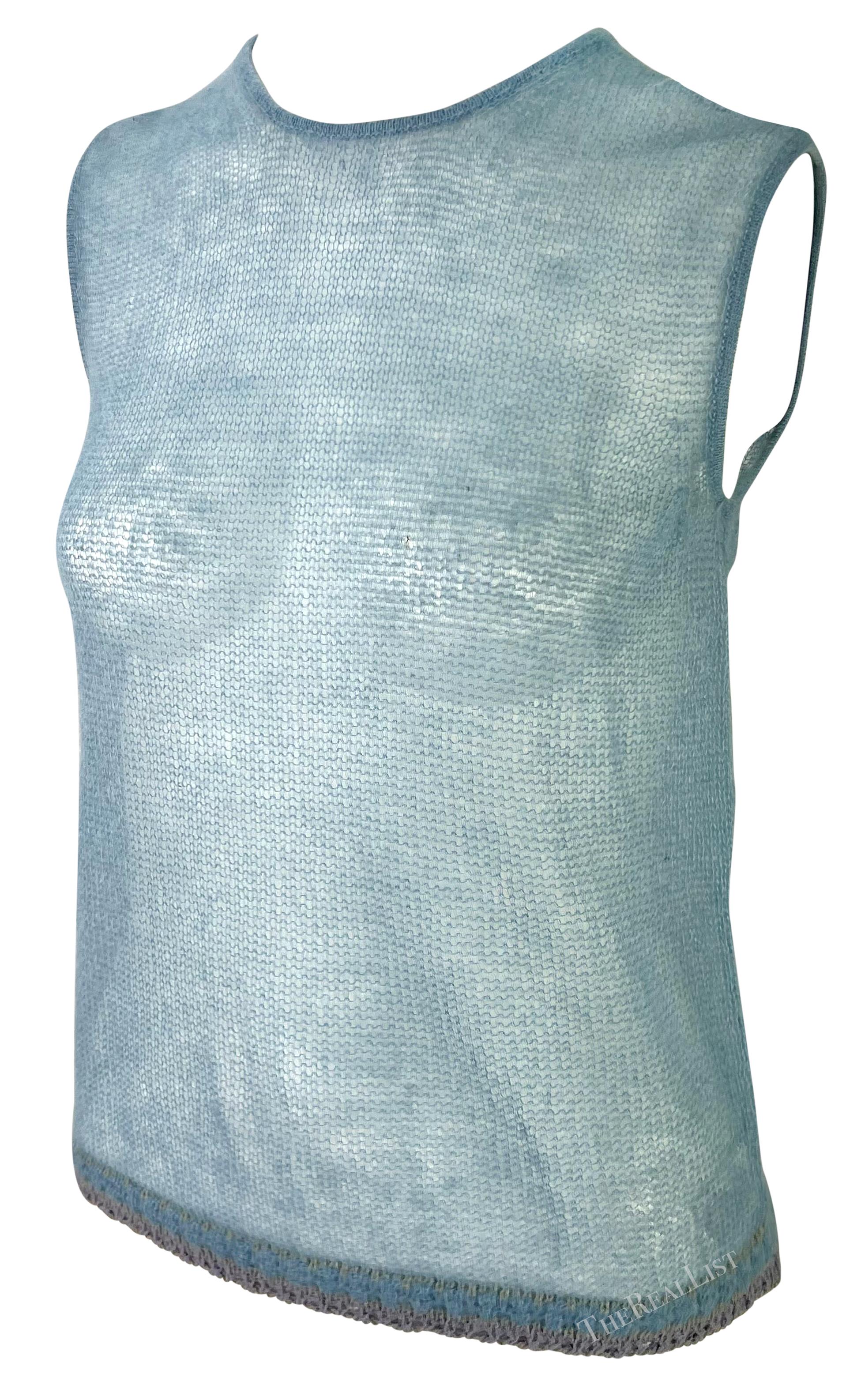 This 1999 Giorgio Armani sleeveless sweater top features a sheer knit design in a soft baby blue. With its minimalist style and lightweight fabric, this piece reflects Armani's timeless and elegant approach to fashion.

Approximate