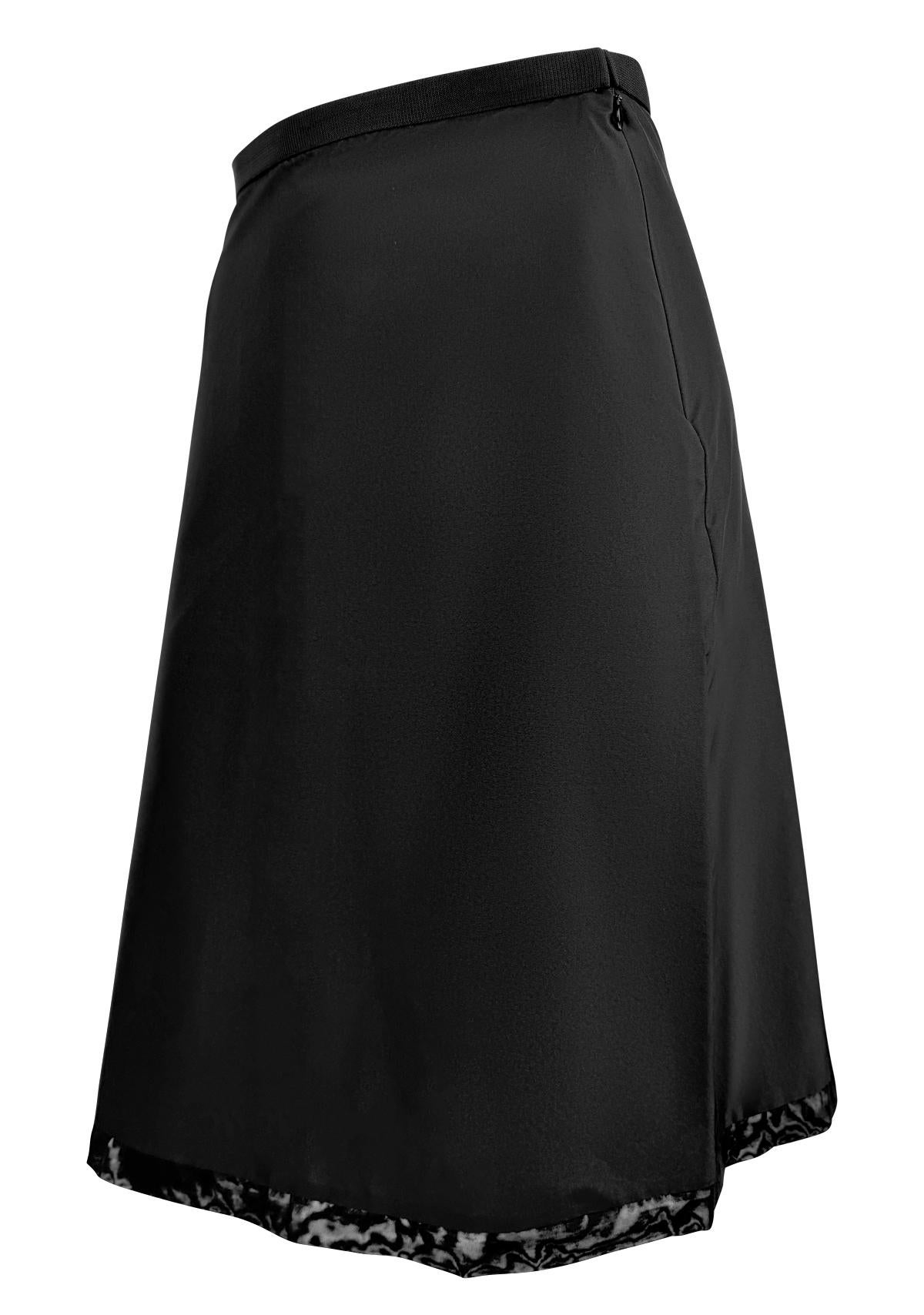 Presenting a black nylon skirt from Gucci, designed by Tom Ford for the 1999 collection. This minimal a-line silhouette is finished with a sheer black mesh trim at the hem.

Approximate measurements:
Size - IT38 
Waistband to hem: 24.5”
Waist: