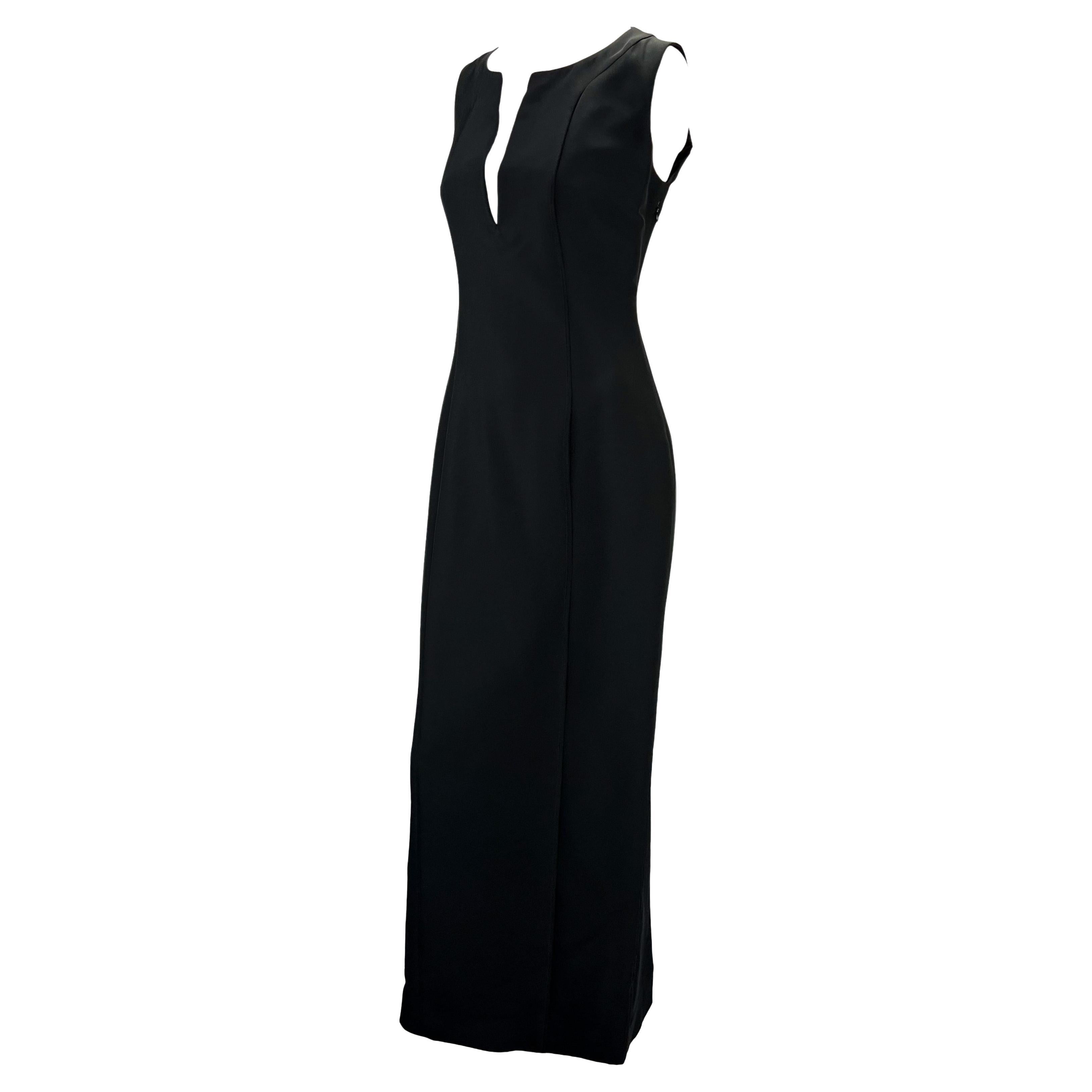 Presenting a black silk-blend Gucci column dress designed by Tom Ford. From 1999, this beautiful sleeveless dress features a plunging neckline, slit at the back, and fitted waist. Effortlessly chic, this floor-length dress is sure to wow.