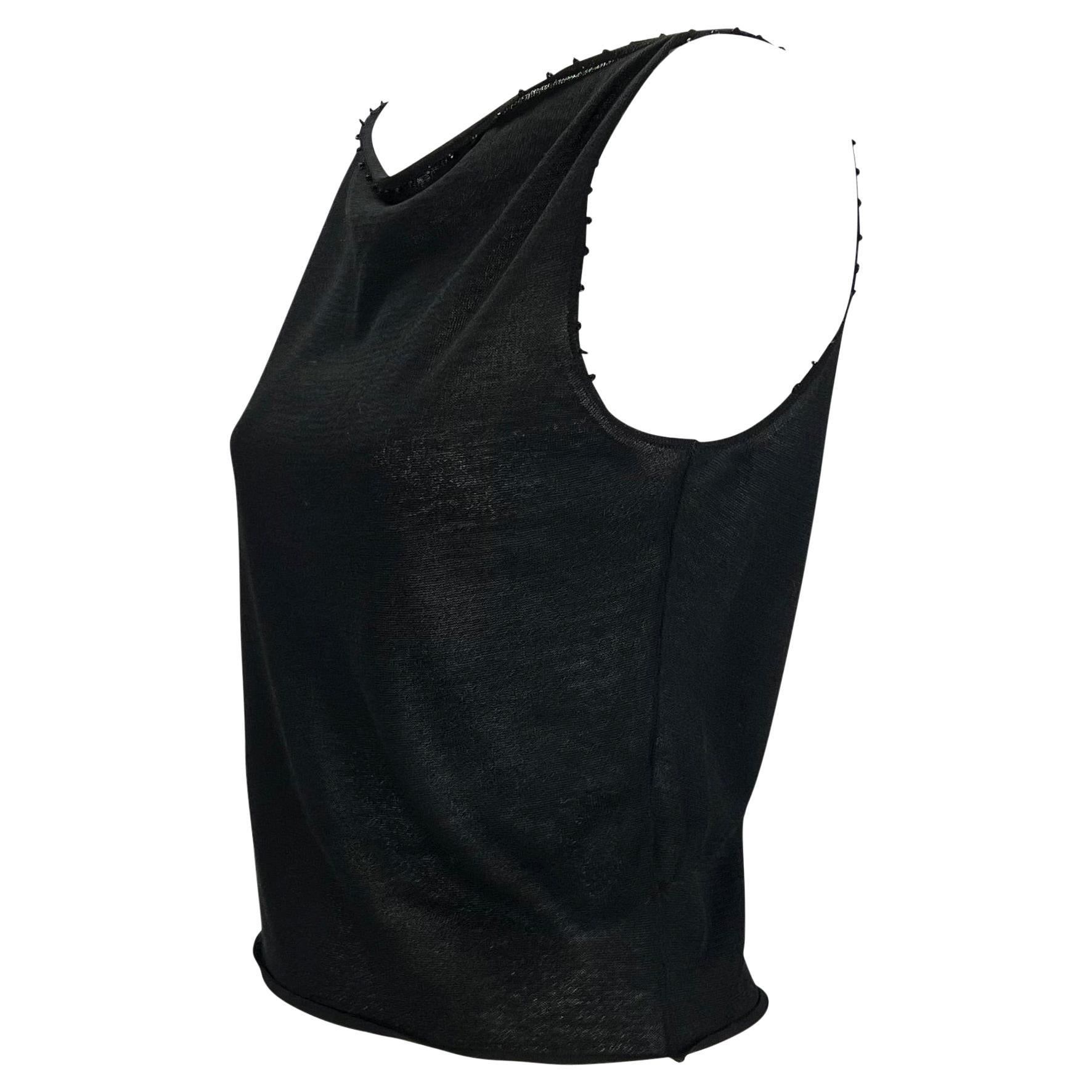 TheRealList presents: a black knit Gucci tank top, designed by Tom Ford. From 1999, this fabulous top features a wide neckline with a cowl effect. The top is elevated with caviar beads sewn around the neckline and armholes. Not your average tank