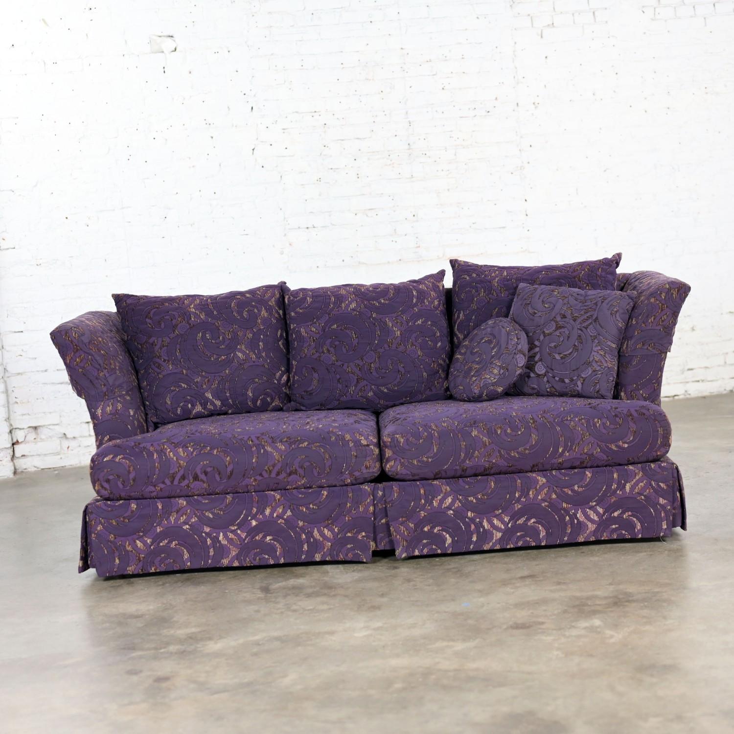 Marvelous vintage Modern to Hollywood Regency overscale modified tuxedo style sofa wearing “Fantasy Eggplant” fabric on loose zippered poly/foam filled seat & back cushions, arm covers, 2 matching accent pillows, & standing on round wood legs under