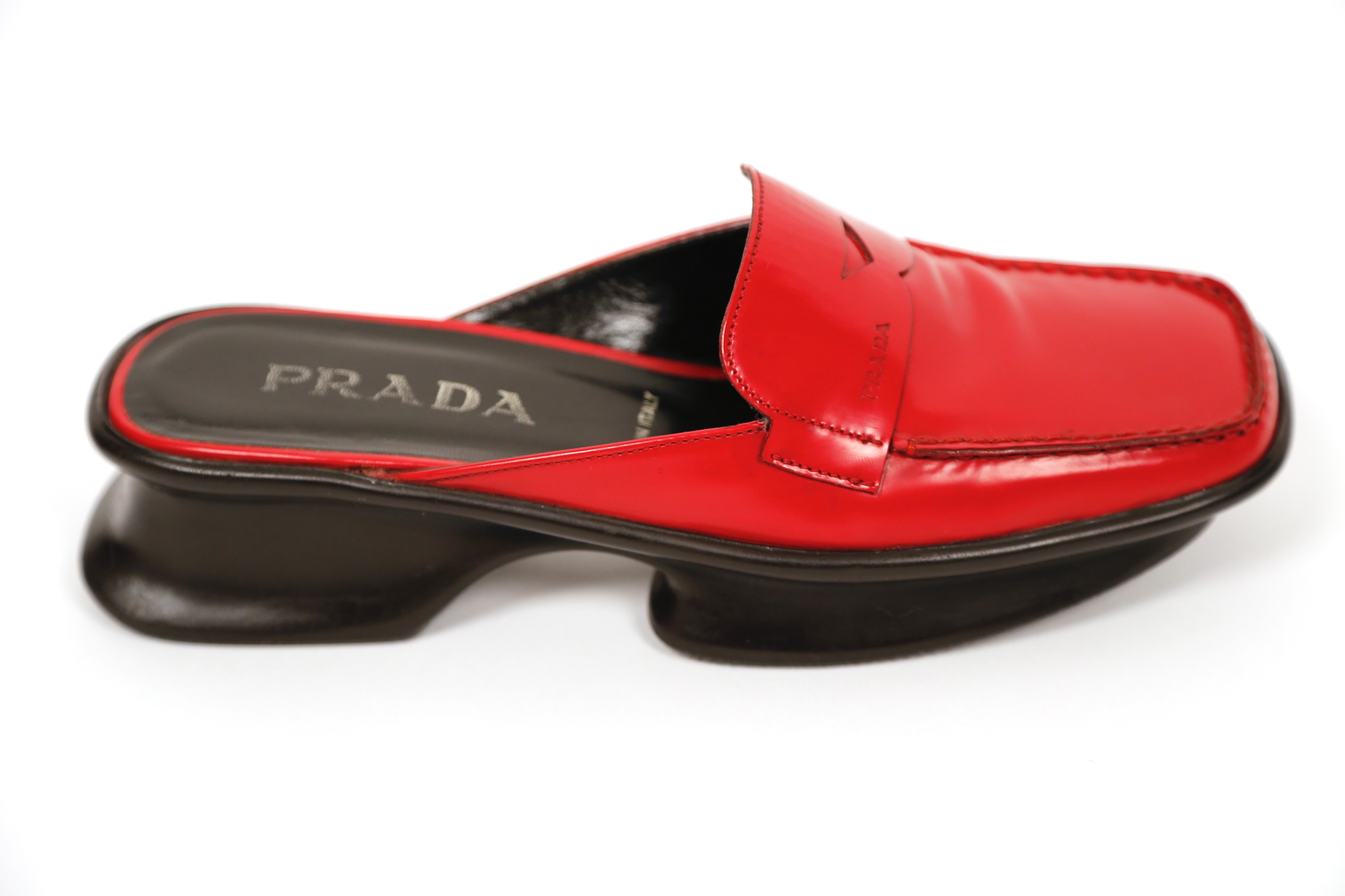 Red, polished-leather, platform loafers with split soles from Prada dating to spring of 1999. Labeled a size 36.5. Slide on. Made in Italy. Very good condition.
