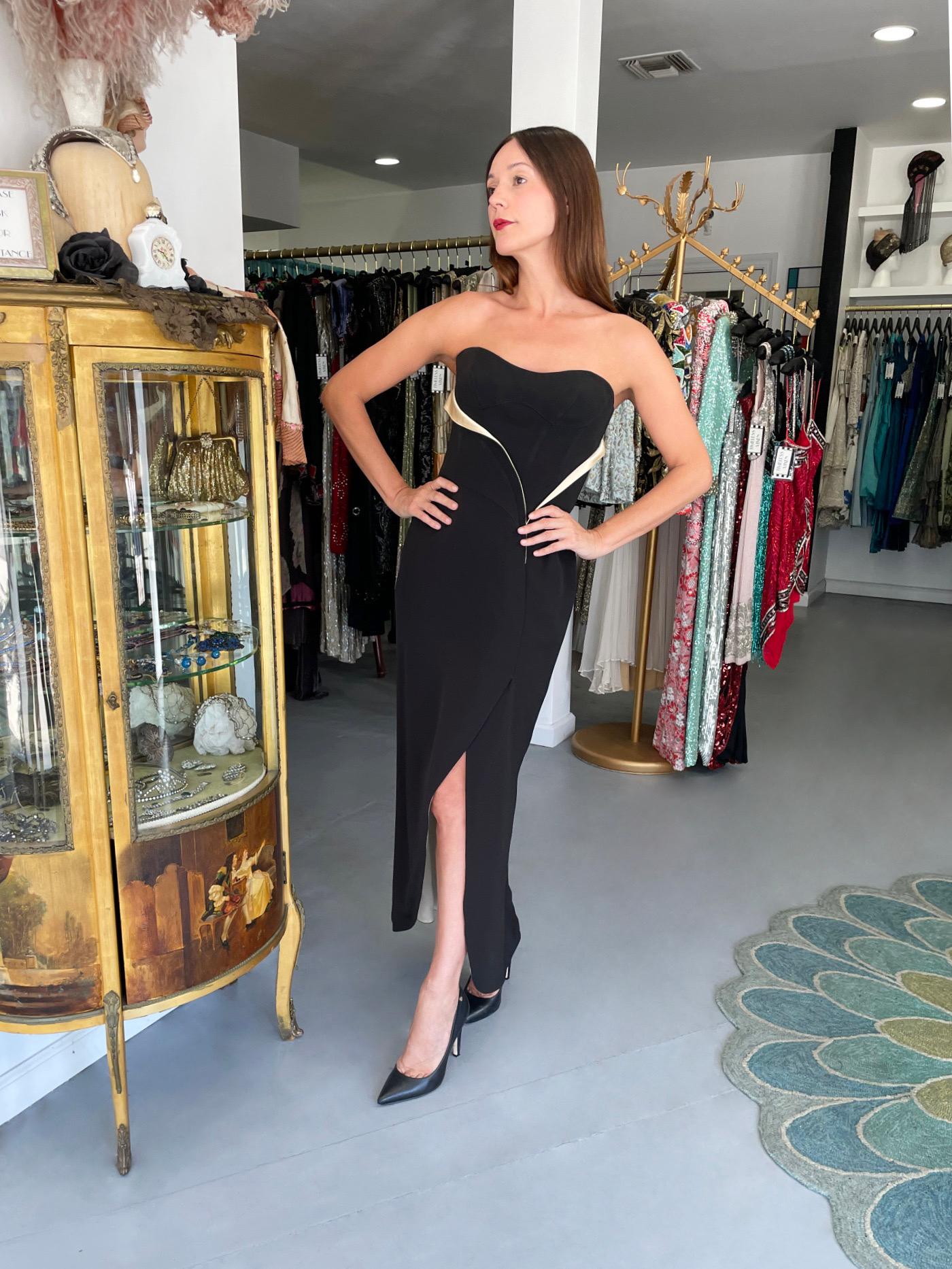 A super seductive and highly coveted Thierry Mugler couture black silk and ivory satin strapless bustier hourglass gown dating back to his 1999 spring/summer collection. This legendary French fashion designer is known for bold fashion and edgy,