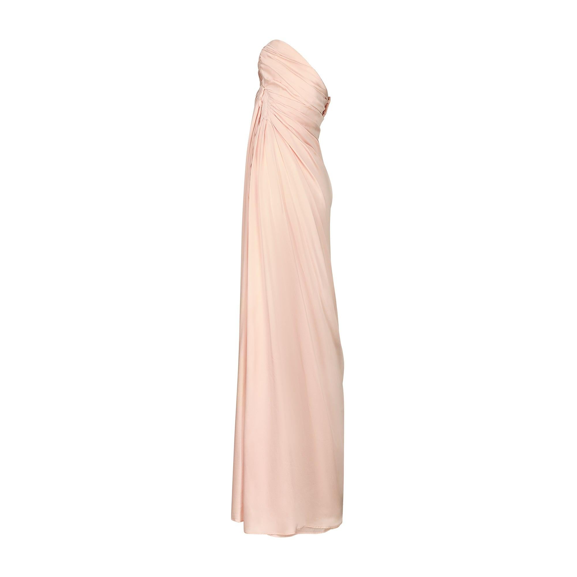 This muted pink silk dress was the spectacular finale dress in Thierry Mugler’s Fall 1999 collection. Designed by the master of empowering, hyper-feminine tailoring, it sculpts the body in a manner that recalls Grecian draping. The dress is composed