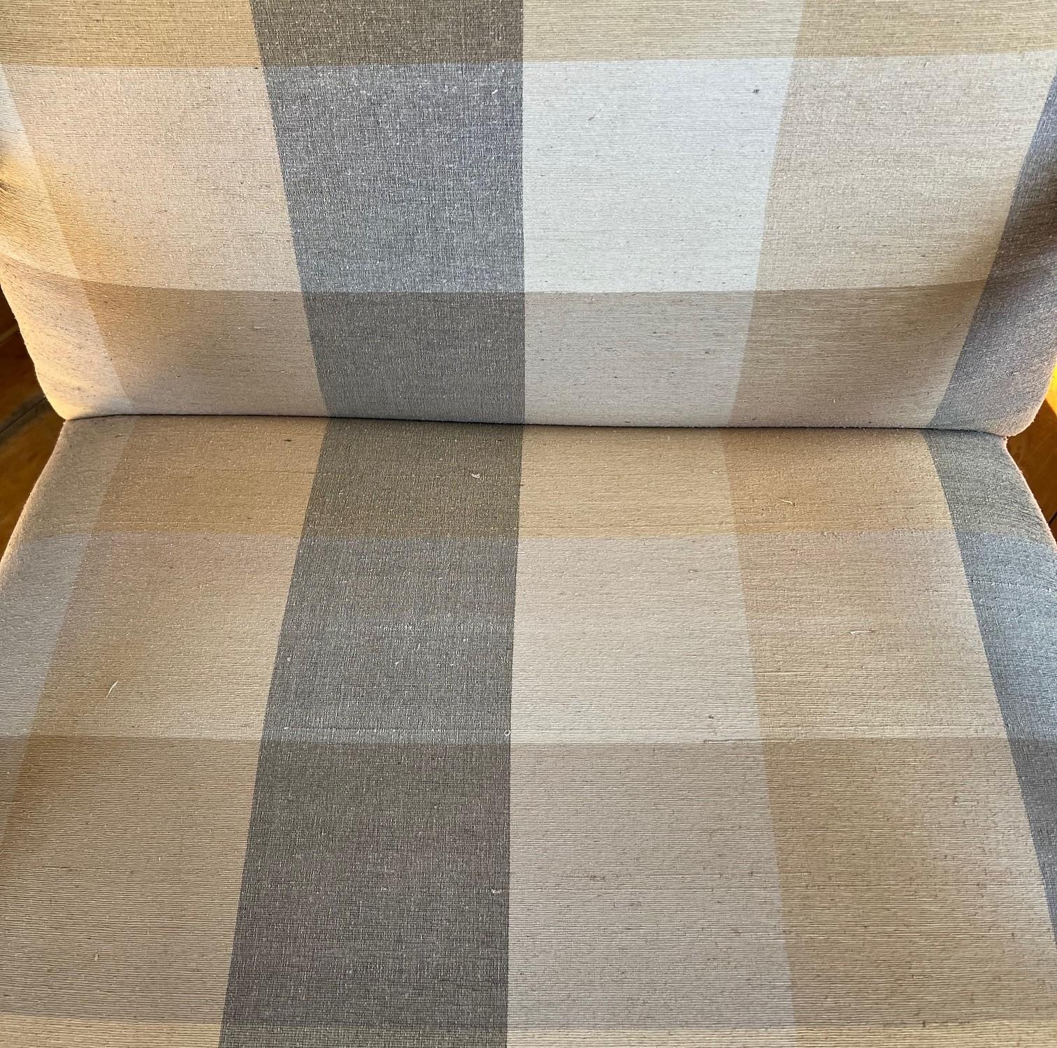 This elegant armchair by Vanguard Furniture (Hickory, North Carolina) is a beautiful blend of classic design and modern comfort. The chair features a solid wood frame with intricate hand-carved details, including shell motifs and scrollwork,