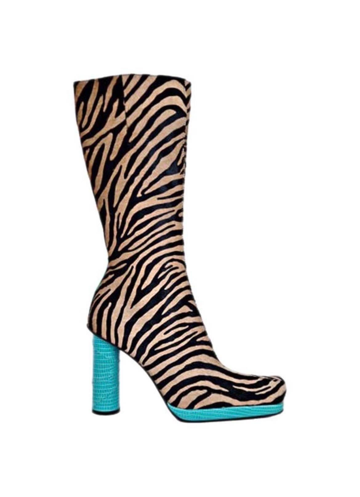 An amazing pair of Gianni Versace runway boots from 1999 Fall/Winter Collection. 
Animal print fur is combined with turquoise lizard skin.  
Leather lining, leather sole.  Side zipper.  
Size 36.5 
Unworn.  
Excellent condition.

Matching runway bag