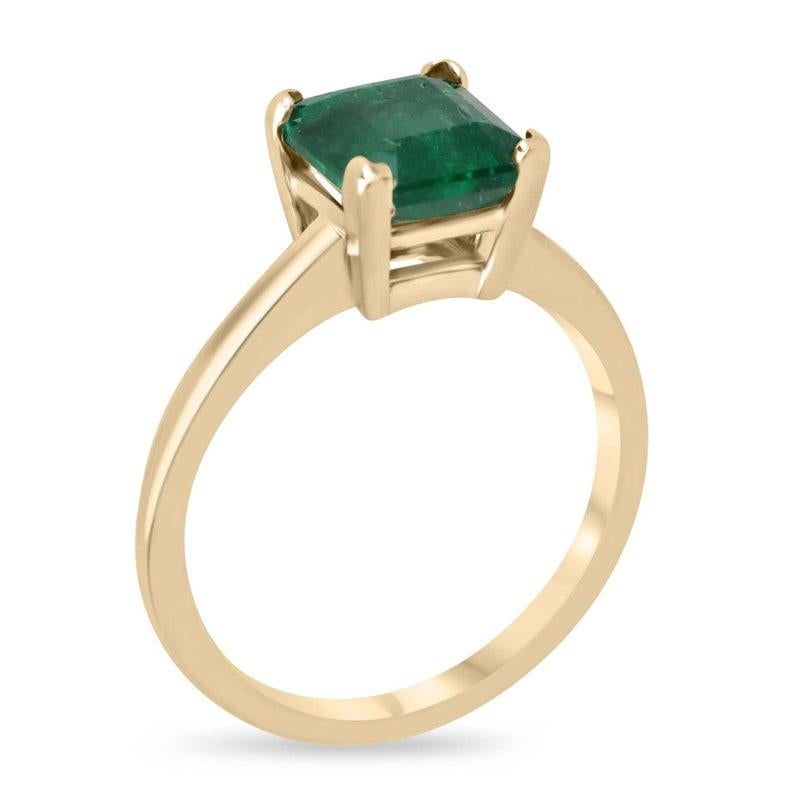 Embrace timeless sophistication with our solitaire emerald engagement ring, showcasing a breathtaking 1.99-carat asscher-cut emerald of deep green hue and semi-transparent clarity, elegantly cradled in a four V-shaped prong setting crafted from