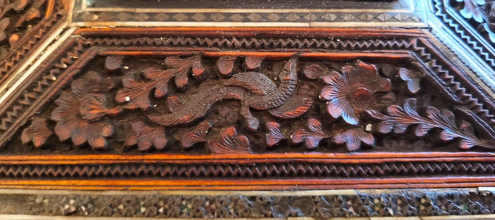 PRESENTING A LOVELY 19C Anglo Indian Highly Carved Padouk Wood with Sadeli Mosaic Inlay Sewing Box.

Made in Bombay, India, circa 1880.

The box is made of sandalwood with highly carved raised padouk wood panels on all sides, depicting temple