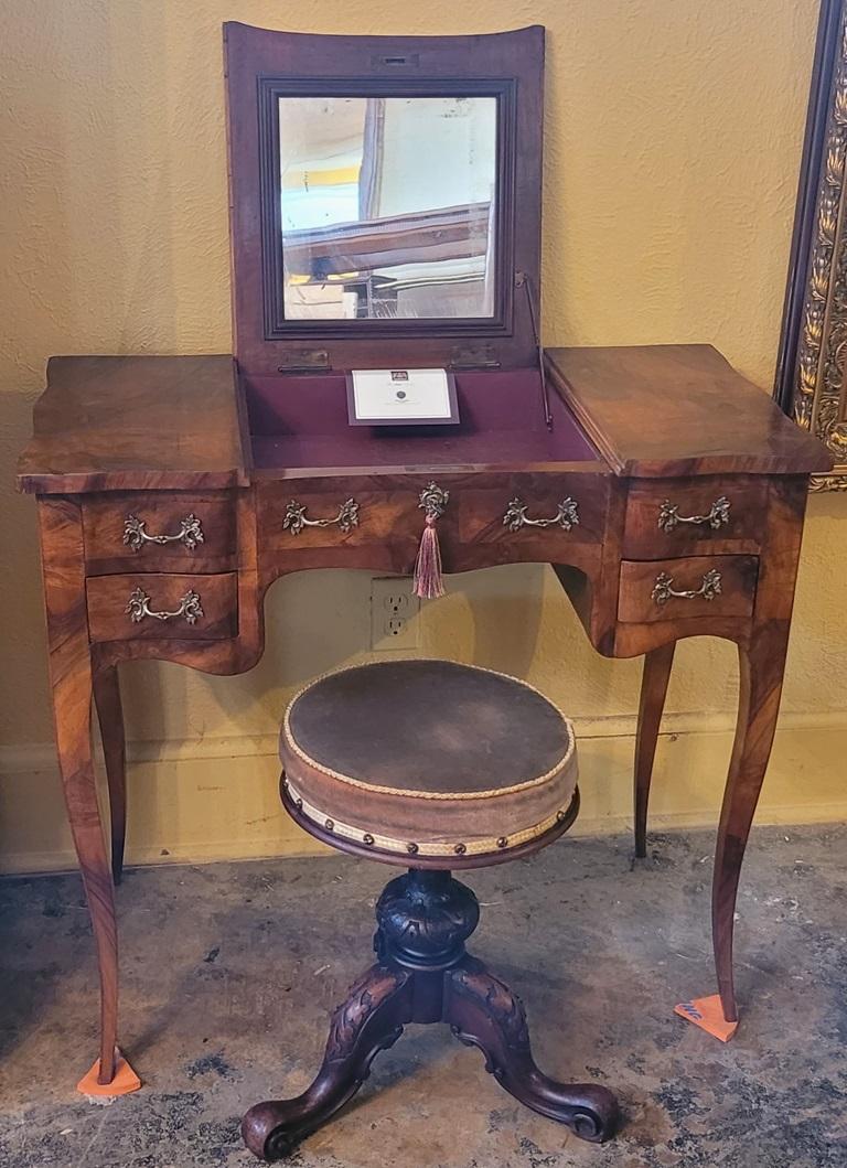 PRESENTING A LOVELY, mid-19th Century, British Victorian Telescopic or Adjustable Piano or Vanity Stool, from circa 1860.

The cushioned seat turns clockwise and counter-clockwise to raise and lower its height.

The stool sits on a heavily carved