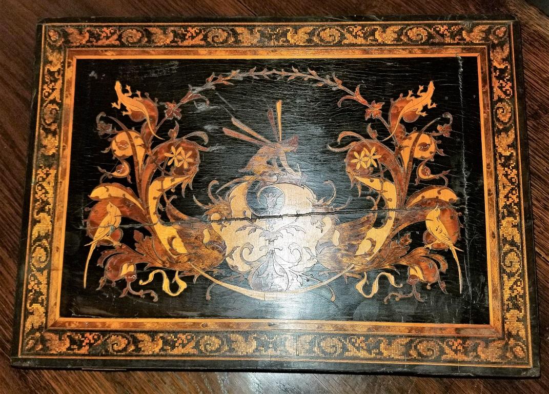 Presenting an absolutely gorgeous and extremely unique and rare 19th Century British Tunbridge ware lap desk.

This lap desk is unlike any of it’s kind we have seen before.

From circa 1840-1860.

Made of ebony with gorgeous marquetry inlay on all